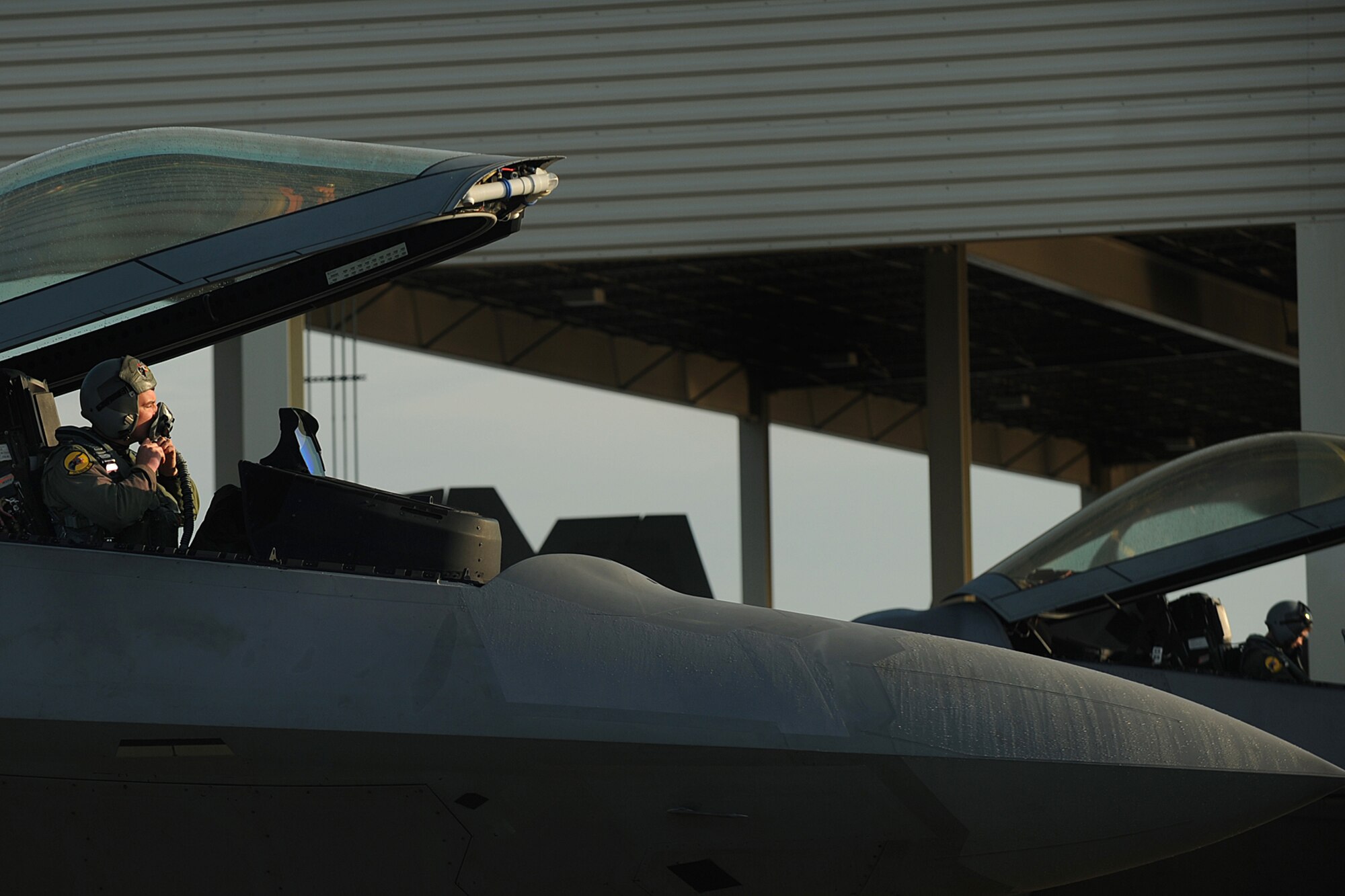 LANGLEY AIR FORCE BASE, Va. --  F-22A Raptor pilots put their helmets on just before taking off for a deployment to Kadena Air Base, Japan, Jan. 7.  More than 200 personnel and 12 F-22A Raptors from the 27th Fighter Squadron departed for Japan for their Air Expeditionary Force deployment, which demonstrates the continued U.S. commitment to fulfill it security responsibilities through the Western Pacific.  (U.S. Air Force photo/Senior Airman Vernon Young)
