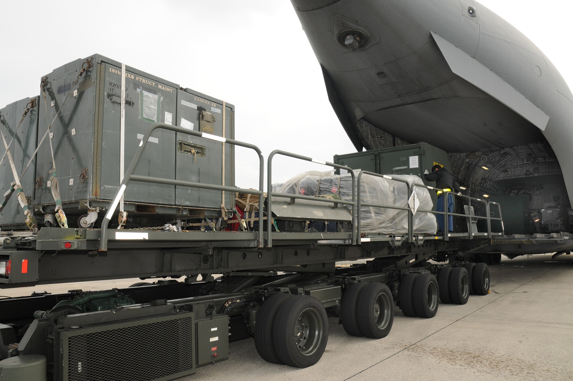 Airmen and civilian workers unload cargo from a C-17 Globemaster III aircraft at Kadena Air Base, Japan Jan. 7, 2009. The aircraft, stationed at McChord Air Force Base, Alaska, traveled to Kadena carrying supplies along with several Airmen returning from a deployment to Bagram Air Base, Afghanistan. (U.S. Air Force photo/Airman 1st Class Chad Warren)