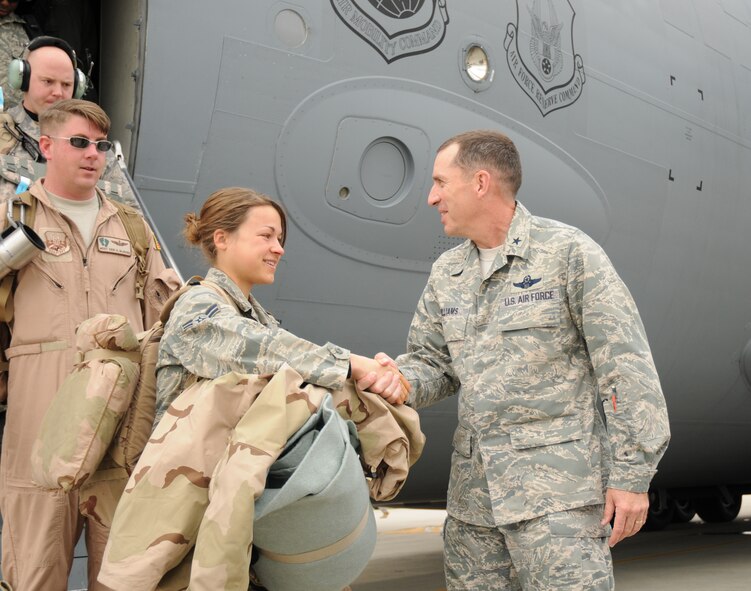 Brig. Gen. Brett T. Williams, 18th Wing commander, greets Airman 1st Class Kristie Miller from the 718th Aircraft Maintenance Squadron at Kadena Air Base, Japan Jan. 7. Airman Miller and several others from the 33rd Rescue Squadron just returned from a deployment to Bagram Air Base, Afghanistan. (U.S. Air Force photo/Airman 1st Class Chad Warren) 
