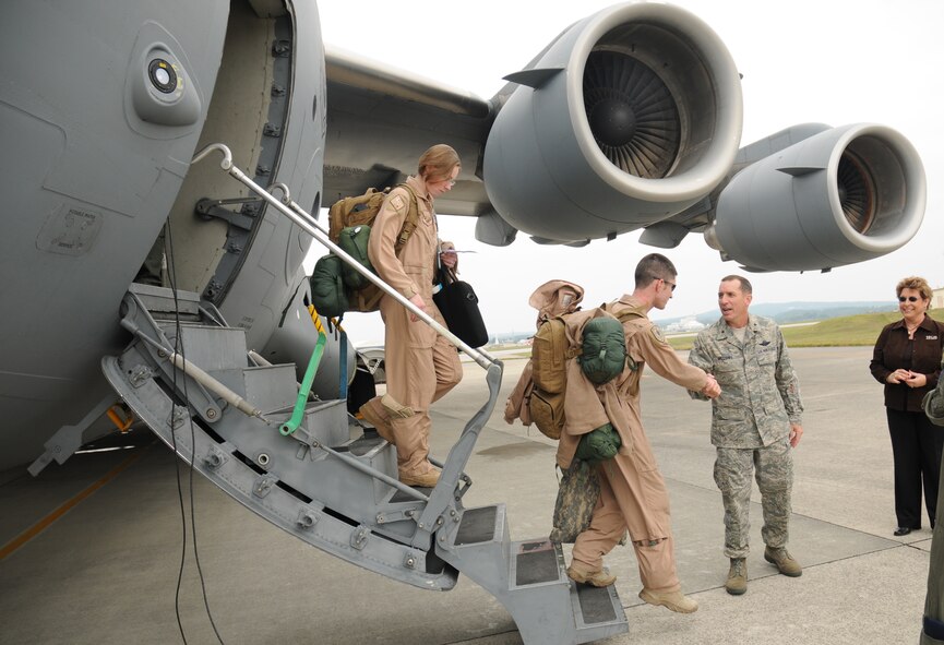 Brig. Gen. Brett T. Williams, 18th Wing commander, greets returning Airmen from the 33rd Rescue Squadron at Kadena Air Base, Japan Jan. 7. These Airmen were the first of four groups returning from a deployment to Bagram Air Base, Afghanistan. (U.S. Air Force photo/Airman 1st Class Chad Warren) 
