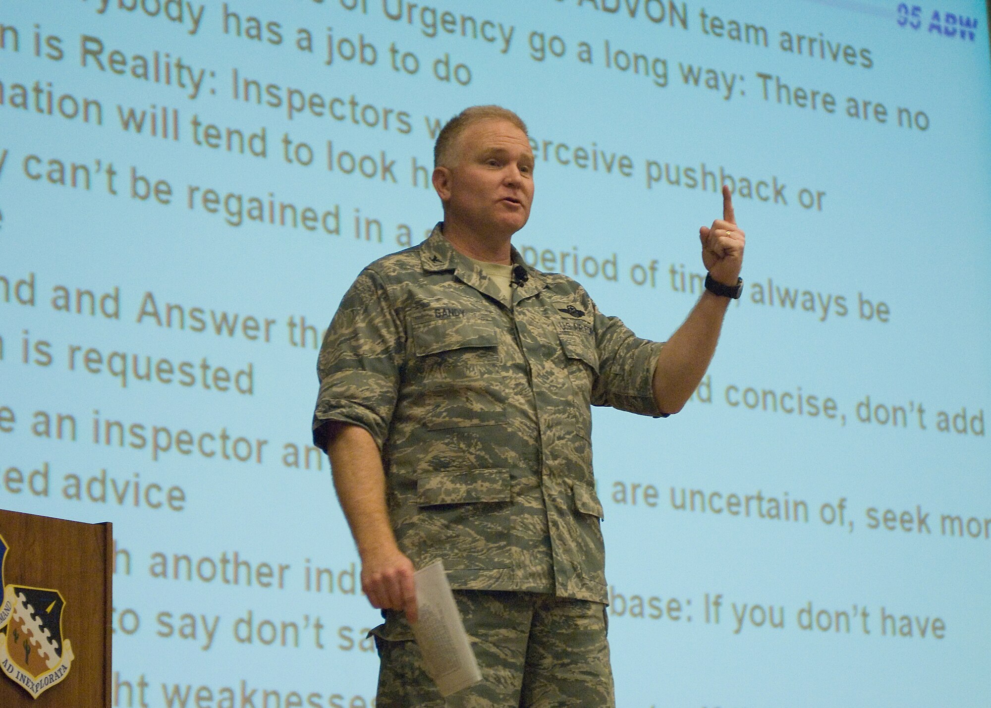 Col. Jerry Gandy, 95th Air Base Wing commander, addresses the upcoming unit compliance inspection during a commander's call at the base theater Jan. 6. (Air Force photo by Mike Yncera)