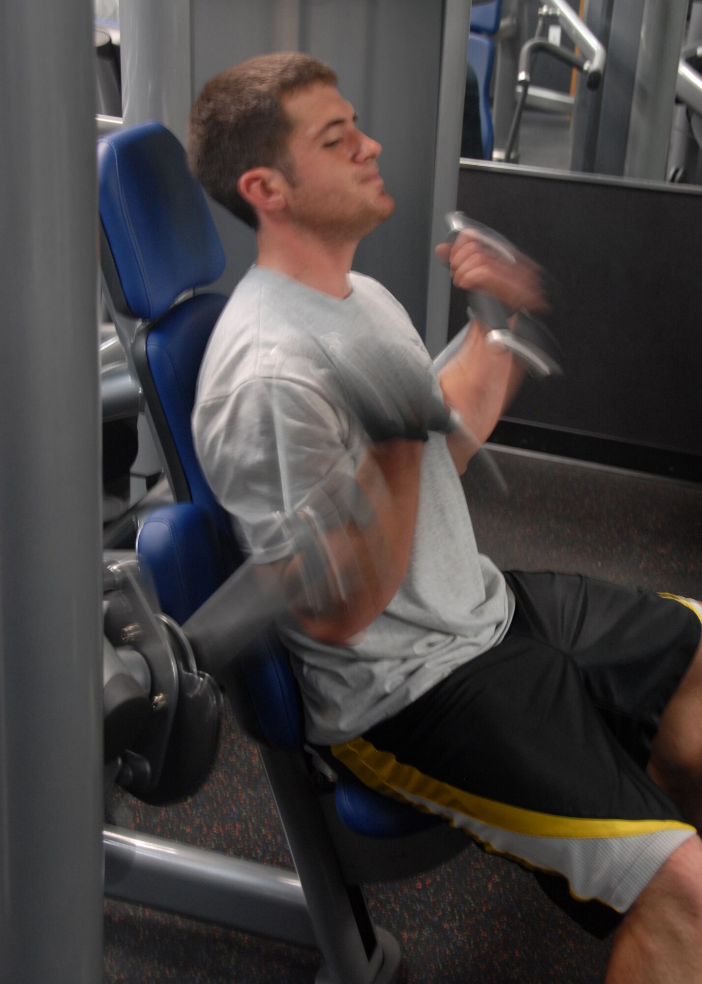 Staff Sgt. Shayne Katirgis lifts weights during his workout session Jan. 5 at the base Fitness and Sports Center. Fitness and Sports Center has more than 60 cardio machines and more than 50 weight machines for Airmen to use to get in and stay in shape. Sergeant Katirgis is with the 701st Airlift Squadron. 