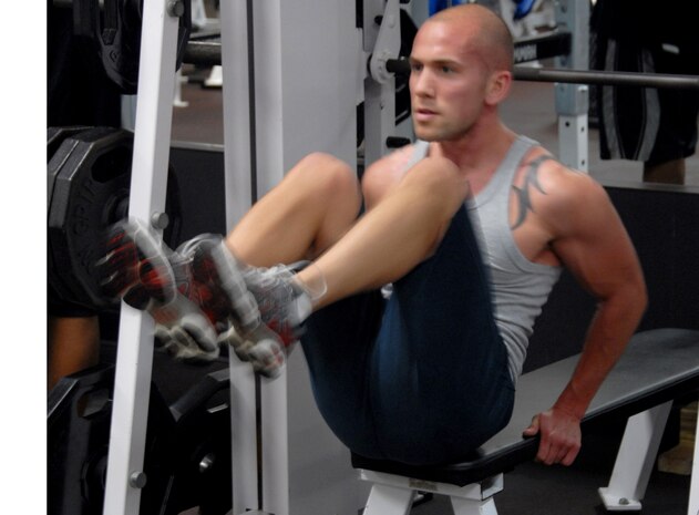Staff Sgt. Brandon Voges completes his crunches at the base Fitness and Sports Center before moving onto the weight lifting portion of his workout Jan. 5. Airmen around the base use the Base and Fitness Center in order to stay and shape and be fit to fight. Sergeant Voges is with the 437th Civil Engineer Squadron.