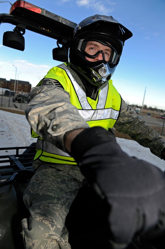 Staff Sgt. John Cooke, 28th Security Forces Squadron assistant NCO in charge of mobility, tests the maneuverability of all-terrain vehicle equipped with a rubber track conversion system and emergency lights Jan. 6, here.  The emergency lights increase visibility and improve safety. (U.S. Air Force photo/Senior Airman Marc I. Lane)