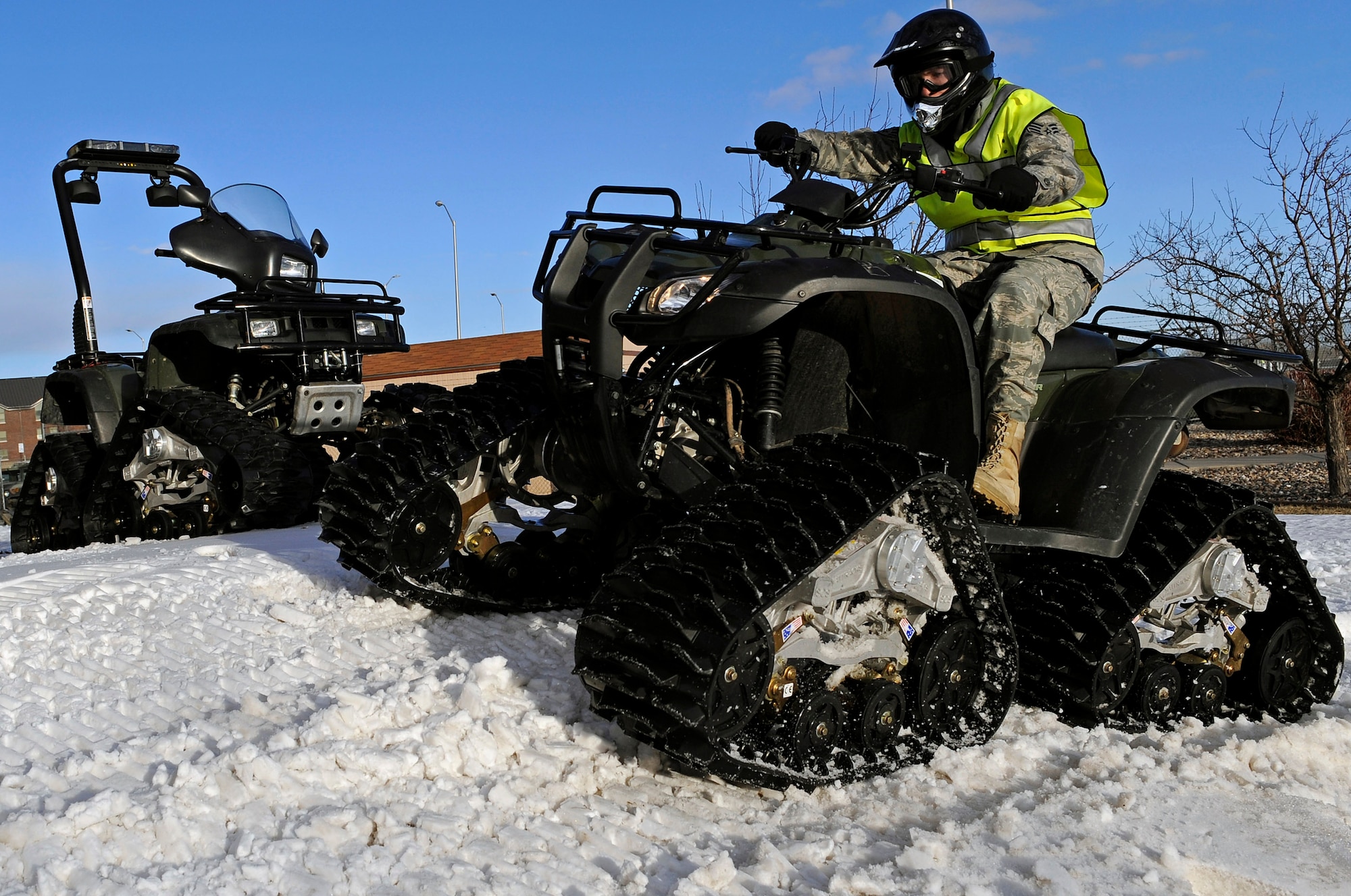 Staff Sgt. John Cooke, 28th Security Forces Squadron assistant NCO in charge of mobility, tests the maneuverability of a all-terrain vehicle equipped with a rubber track conversion system Jan. 6, here.  The 28 SFS installed rubber tracks on two of their ATVs to improve snow rescue capabilities. (U.S. Air Force photo/Senior Airman Marc I. Lane)