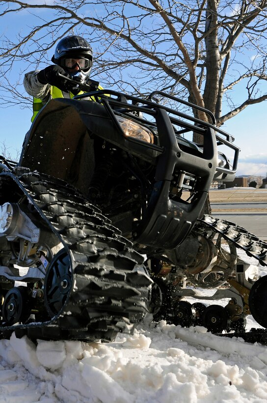 Staff Sgt. John Cooke, 28th Security Forces Squadron assistant NCO in charge of mobility, tests the maneuverability of an all-terrain vehicle equipped with a rubber track conversion system Jan. 6, here. The tracks are wider than standard ATV tires and allow for quicker travel over snow. (U.S. Air Force photo/Senior Airman Marc I. Lane)