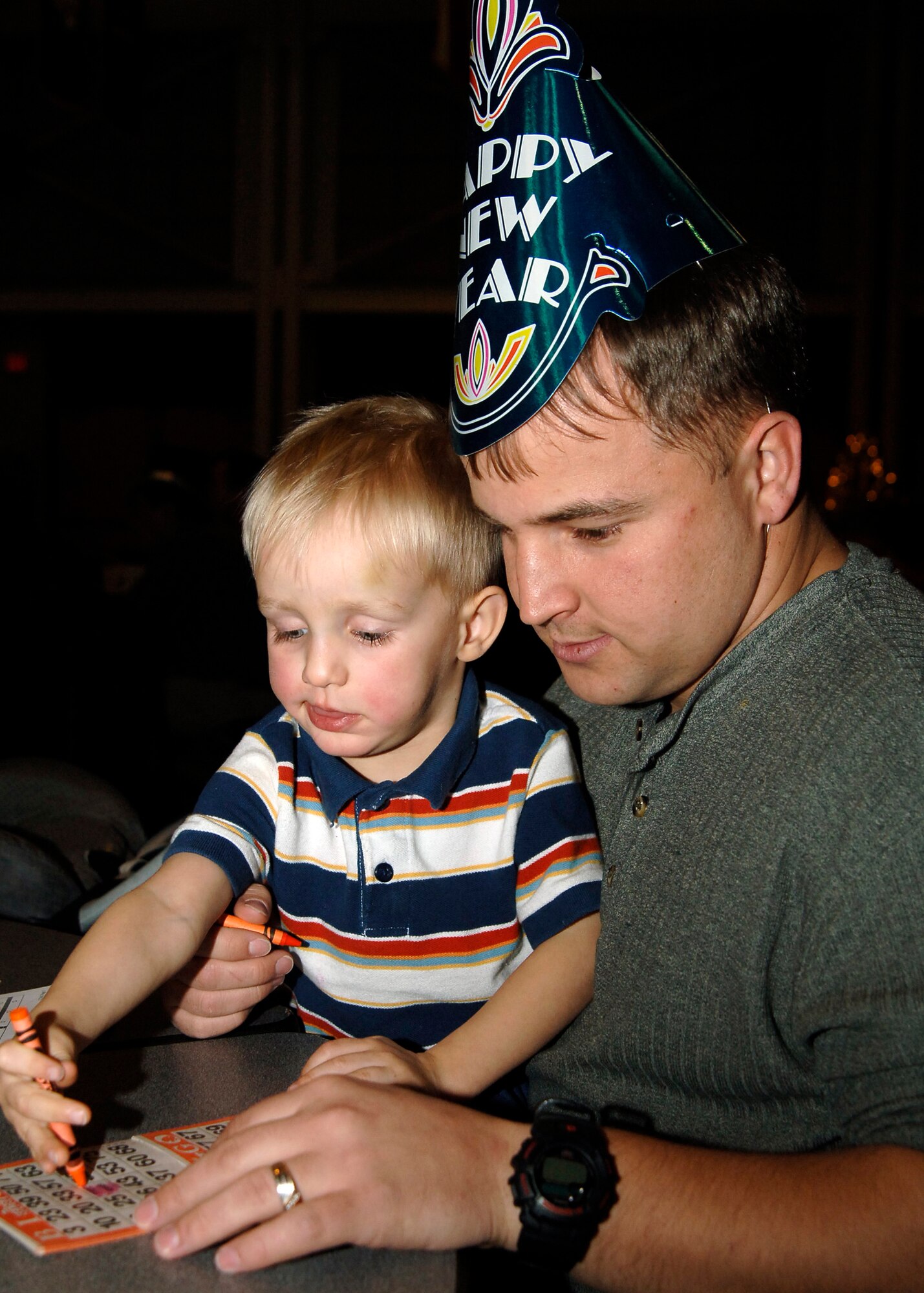MCCONNELL AIR FORCE BASE, Kan. -- Capt. Todd Rotramel, 412th Electronic Warfare Group and his son Evan, 2, spend leave celebrating New Year at Robert J.  Dole Community Center New Years Eve gathering, Dec 31. (Photo by Tech. Sgt. Genevieve Morris)
