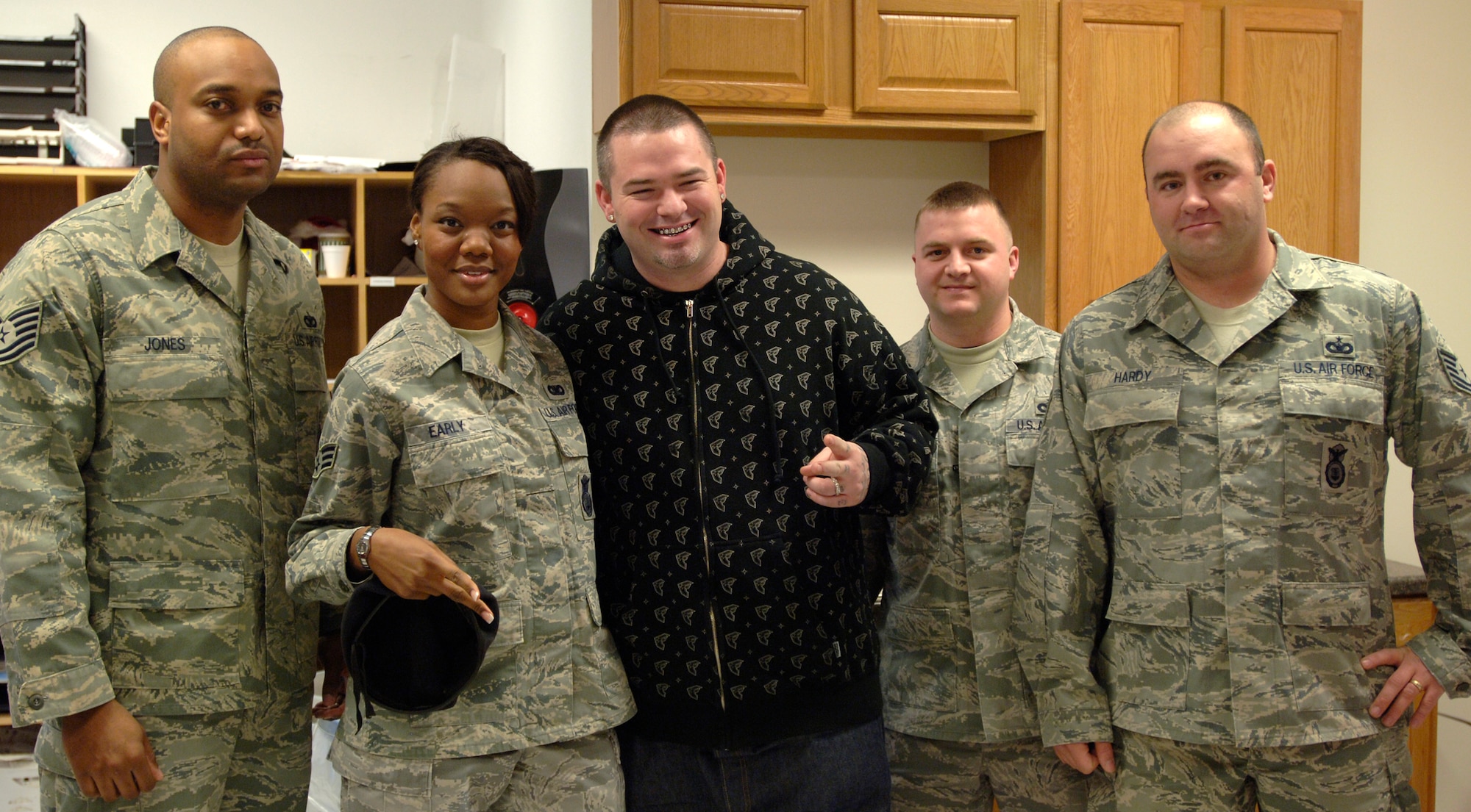 MCCONNELL AIR FORCE BASE, Kan. -- Members from the 22nd Security Forces Squadron meet and greet famous music artist, Paul Wall, Dec. 19 at the base exchange before his performance at the Cotillion in Wichita. (Photo by Senior Airman Laura Suttles) 
