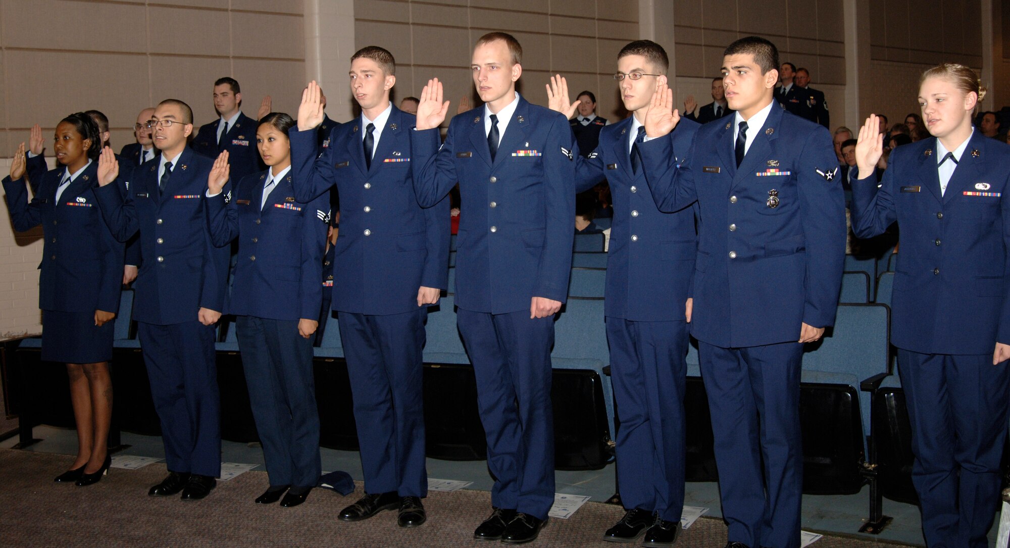MCCONNELL AIR FORCE BASE, Kan. -- Team McConnell members recite the Oath of Enlistment during the monthly wing promotion ceremony at the base theater, Dec. 31. Twenty Airmen were promoted during the ceremony. (Photo by Senior Airman Laura Suttles)