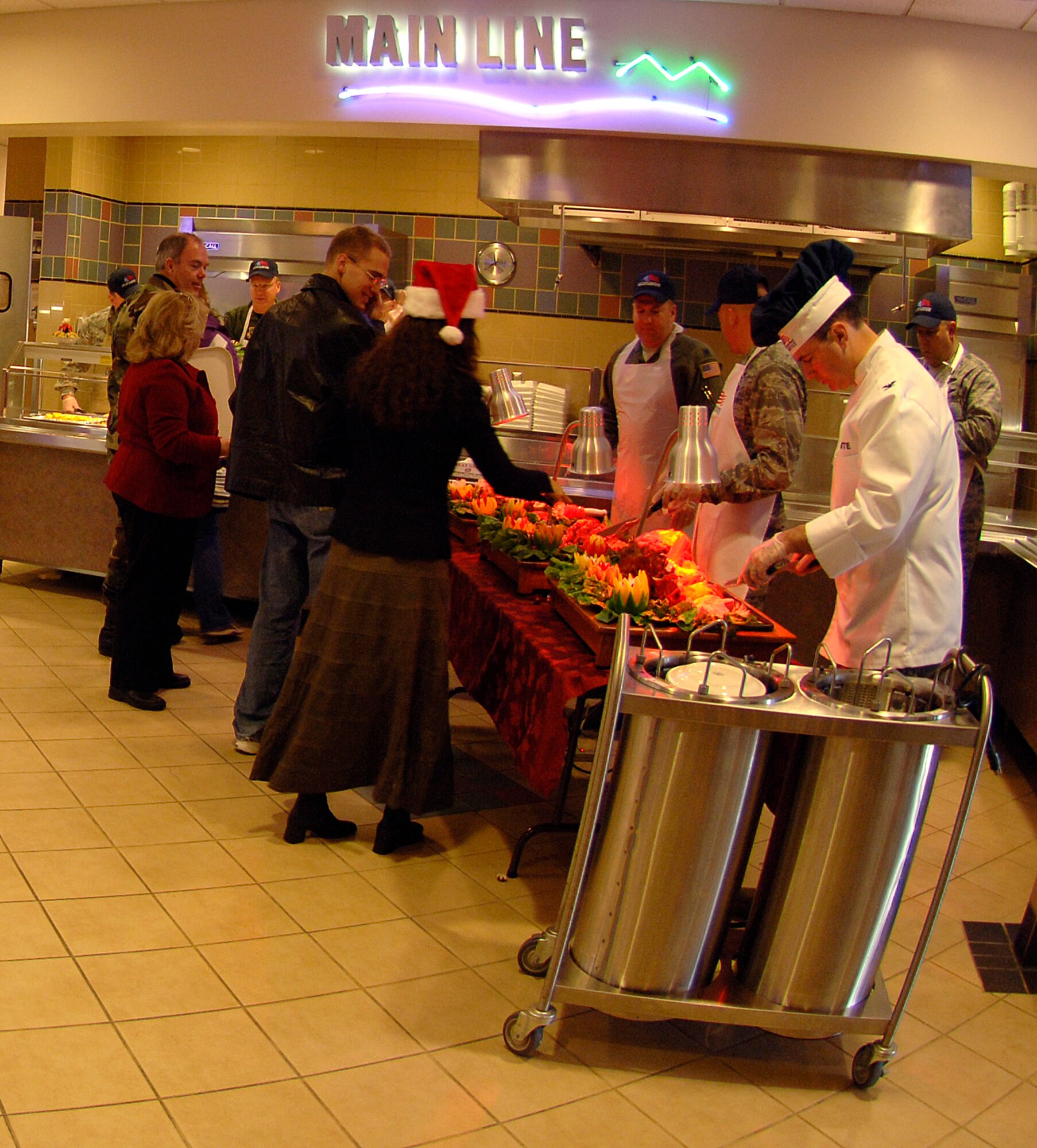 MCCONNELL AIR FORCE BASE, Kan. -- Team McConnell members celebrate the holiday season as wing leadership serves lunch in the Chisholm Trail Dining Facility, Dec. 25. The dining facility was not only open to active-duty military, but families of active duty, DOD civilians and retired personnel as well. (Photo by Senior Airman Laura Suttles) 