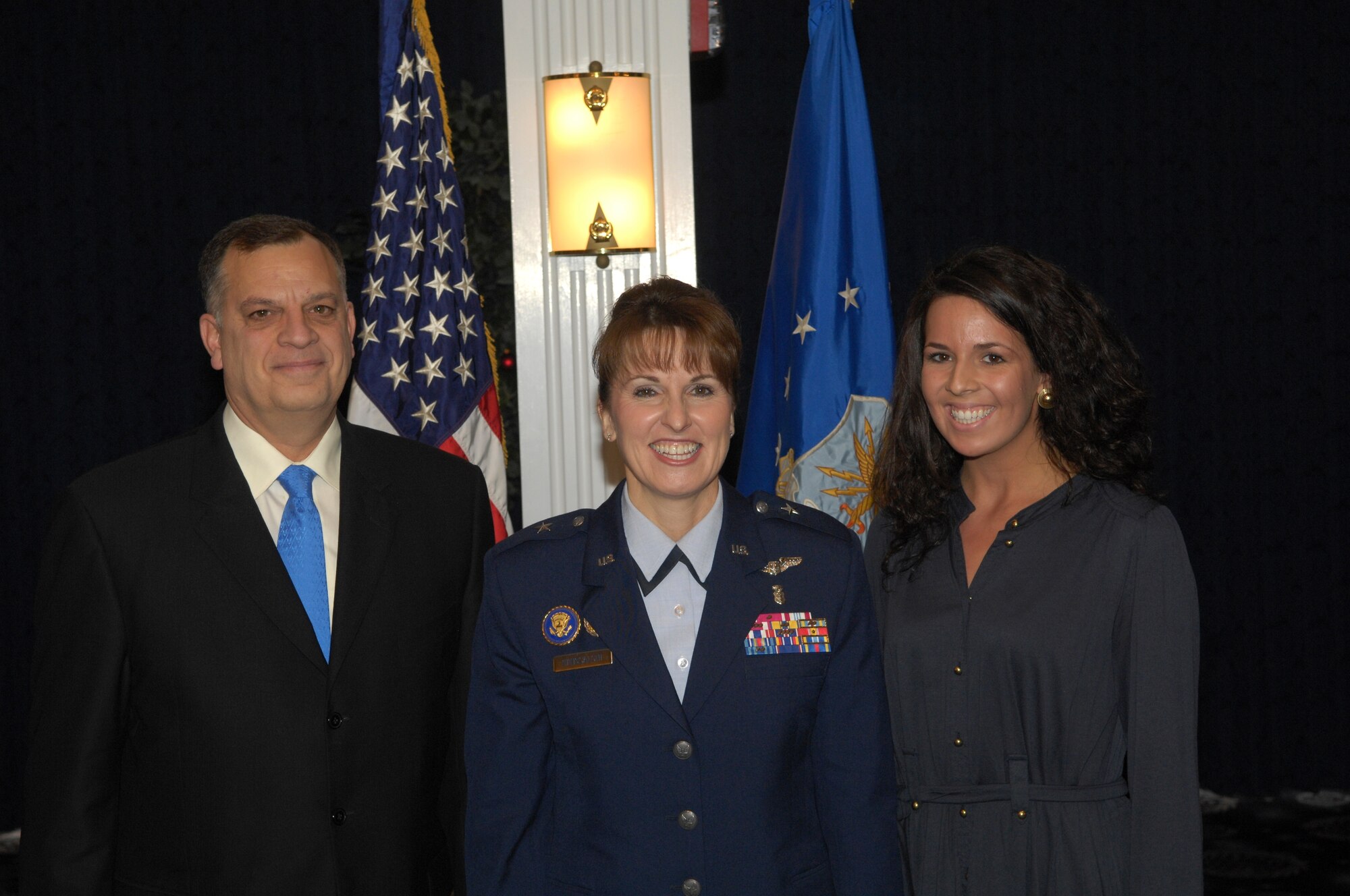 Maj. Gen. Kimberly A. Siniscalchi, center, stands with her husband Joseph and daughter Lauren during her promotion ceremony at the Bolling officers club Dec. 4, during which General Siniscalchi became the new assistant AF surgeon general for medical force development, and assistant AF surgeon general for nursing services. She replaced Maj. Gen. Melissa A. Rank, who retired.  (See related story in this issue.) 