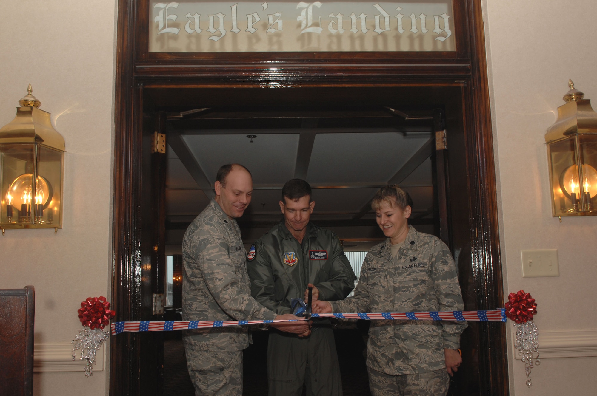 LANGLEY AIR FORCE BASE, Va. -- Lt. Col. Jeff Ullmann, 1st Civil Engineer Squadron commander, Brig. Gen. Mark Barrett, 1st Fighter Wing commander, and Lt. Col. Caroline Miller, 1st Force Support Squadron commander, cut a ribbon during a ceremony reopening the newly renovated officers club. The Langley officers’ club was built in 1934 and after 70 years of normal wear and tear the infrastructure needed to be repaired. The club is now fully equipped with new electrical systems, plumbing, a brand new heating/cooling system, elevator to second floor and handicap accessible restrooms. (U.S. Air Force Photo/Senior Airman Cecil C. McCloud)