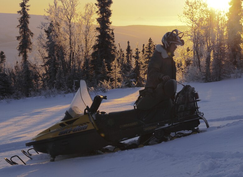 Staff Sgt. Stewart Raring removes a solar pathfinder from a snow machine Dec. 16, 2008, at a remote operating facility in the Pacific Alaska Range Complex in Alaska. The solar pathfinder will measure the intensity of sunlight for an entire year to evaluate "going green" by using solar panels to operate the facility instead of the propane that is currently being used. (U.S. Air Force photo/Airman Laura Max) 