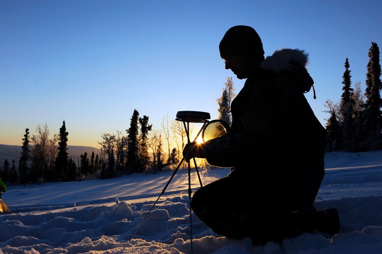 Staff Sgt. Stewart Raring adjusts the solar pathfinder to see an accurate reading Dec. 16, 2008, at a remote operating facility in Alaska. A solar pathfinder shows the year-round, site-specific solar data to determine the best location and angle to setup solar panels. Currently Det. 460 members plan on constructing a solar hybrid power system at seven different locations replacing their current propane power source saving more than $100,000 in maintenance and refueling over a five-year period. He is assigned to Det. 460 at Eielson Air Force Base, Alaska. (U.S. Air Force photo/Senior Airman Jonathan Snyder) 