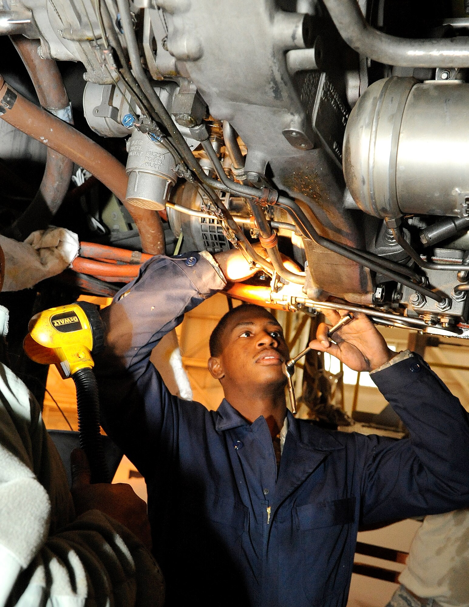 Airman 1st Class Maurice Young, a new 605th Aircraft Maintenance Squadron Jet Shop mechanic, tackles his first major task while supervised, removing and replacing a McGuire KC-10A #2 engine Jan. 6. (U.S. Air Force Photo/Wayne Russell)