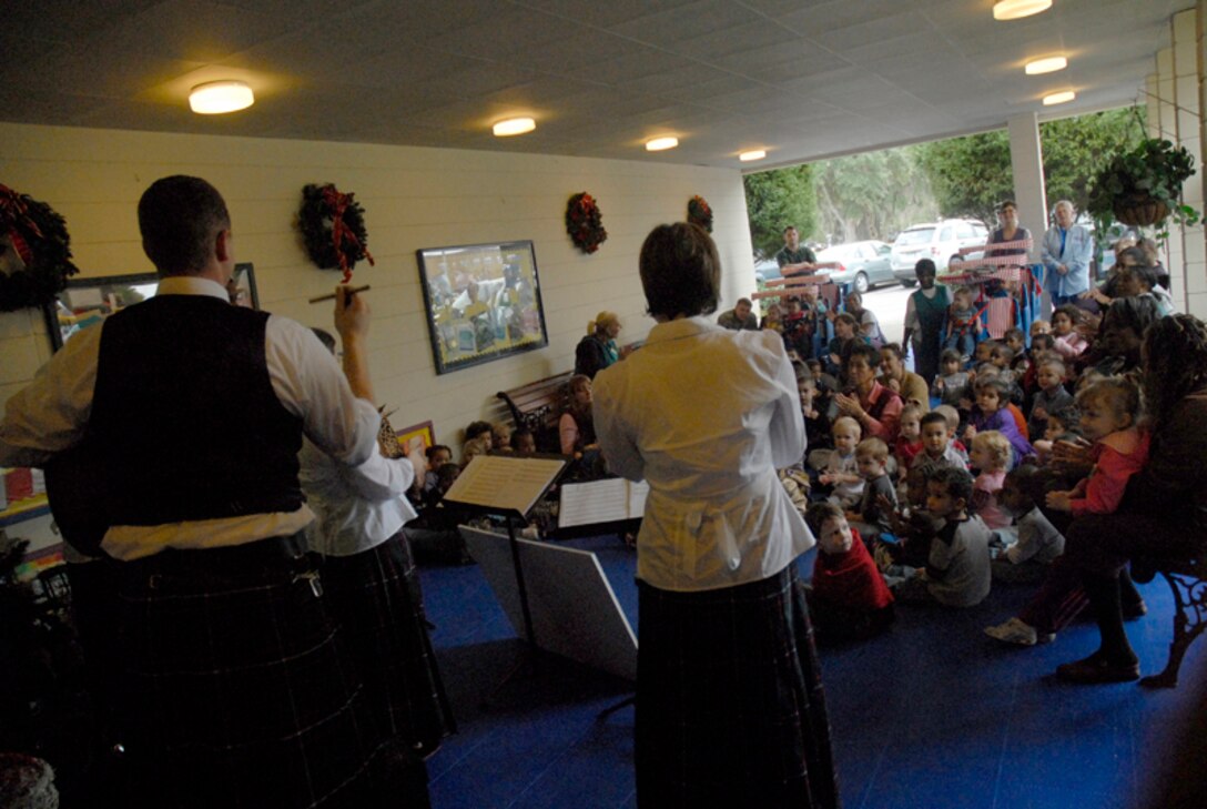 Children from the Child Development Center watch a holiday caroling performance of the Heritage Aire Celtic Ensemble, Langley AFB, VA. Dec. 10. The Air Combat Command band performed for the children at the Child Development Center, blending traditional music of Ireland, Scotland and England with a contemporary musical style creating a stunning musical tapestry. (U.S. Air Force photo/Tech. Sgt. David Watson) 