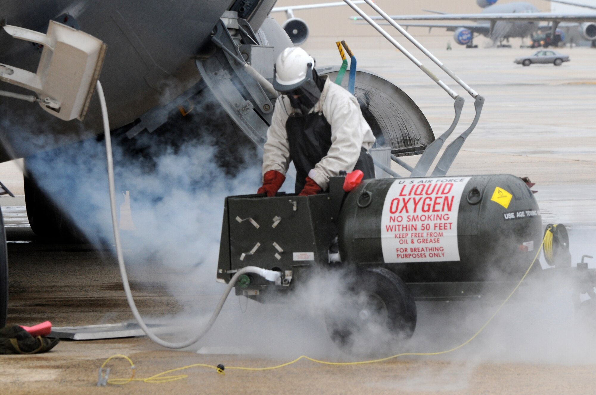 Airman 1st Class Lindsay Hanford, 305th Aircraft Maintenance Squadron, replenishes liquid oxygen on a McGuire C-17 Jan. 6. As the liquid vents, it turns into a gas and creates a fog effect. (U.S. Air Force photo/Wayne Russell)