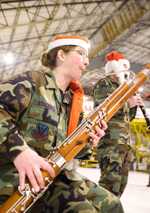 Tech. Sgt. Julie Stockdill, U.S. Air Force Heritage of America 'Langley Winds' band member, performs for Dover Airmen Dec. 16. The U.S. Air Force Heritage of America Band 'Langley Winds' is a five-member active duty group with a long history of entertaining the American public and promoting esprit de corps within the military.  Consisting of several unique musical ensembles, the USAF Heritage of America Band performs for more than one million people throughout a six-state region from Pennsylvania to South Carolina each year.  (U.S. Air Force photo/Thomas Randle)   