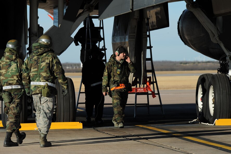 DYESS AIR FORCE BASE, Texas -- Members of the 7th Bomb Wing maintain and load weapons on the B-1B Lancer during the operational readiness inspection here, Jan. 6.  Properly maintaining and loading bombs on the B-1B is crucial to Dyess' mission success.  (U.S. Air Force photo by Staff Sgt. Darcie Ibidapo)