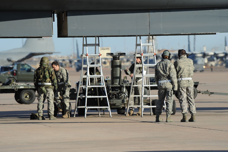 DYESS AIR FORCE BASE, Texas -- Members of the 7th Bomb Wing maintain and load weapons on the B-1B Lancer during the operational readiness inspection here, Jan. 6.  Properly maintaining and loading bombs on the B-1B is crucial to Dyess' mission success.  (U.S. Air Force photo by Staff Sgt. Darcie Ibidapo)