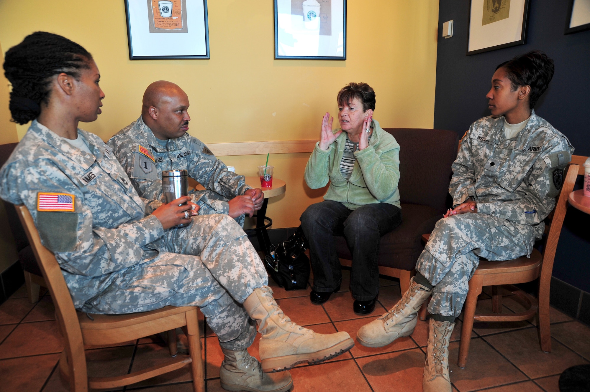 Sgt. 1st Class Pam Ames (in braids), Sgt. John Utsey and Spc. Jessica Welch, Soldiers representing the Colorado Army National Guard, speak with Cindy Barnhill at a Starbucks Coffee store in Centennial Colo., Dec. 29, 2008. In a personal mission spanning two and a half years, Barnhill, of Parker, Colo., has singlehandedly purchased more than $15,000 worth of coffee for service members and first responders in the two communities south of Denver. (Official U.S. Air Force photo by Tech. Sgt. Cheresa D. Theiral, Colorado National Guard) (Released) 