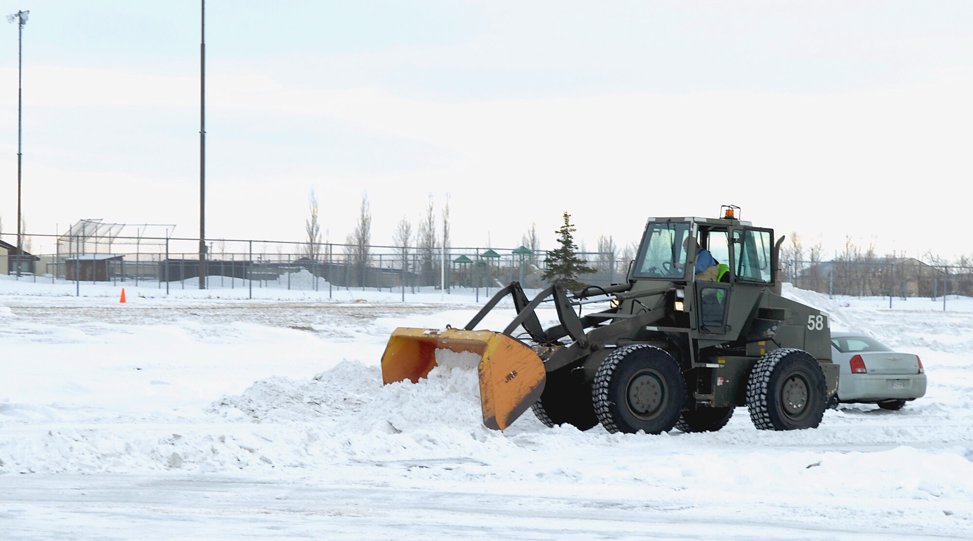 MINOT AIR FORCE BASE, N.D. -- The 5th Civil Engineer Squadron is charged with clearing the snow from all parking lots and roads on base to fulfill mission requirements here. Clearing parking lots is just one of many areas this unit is required to maintain. (U.S. Air Force photo by Airman 1st Class Benjamin Stratton)