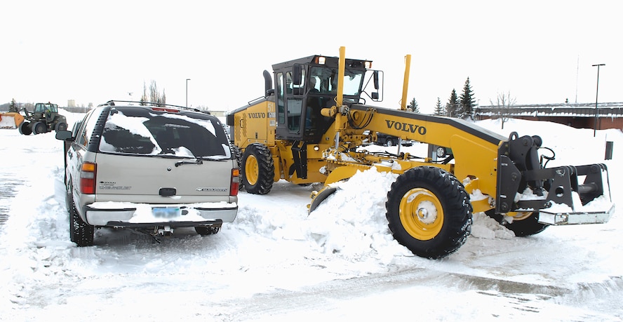 MINOT AIR FORCE BASE, N.D. -- The 5th Civil Engineer Squadron is charged with clearing the snow from all parking lots and roads on base to fulfill mission requirements here. The security forces parking lot is one of the hardest areas to keep clean, as there are always vehicles to maneuver around. This parking lot is just one of many areas cleaned by this unit. (U.S. Air Force photo by Airman 1st Class Benjamin Stratton)