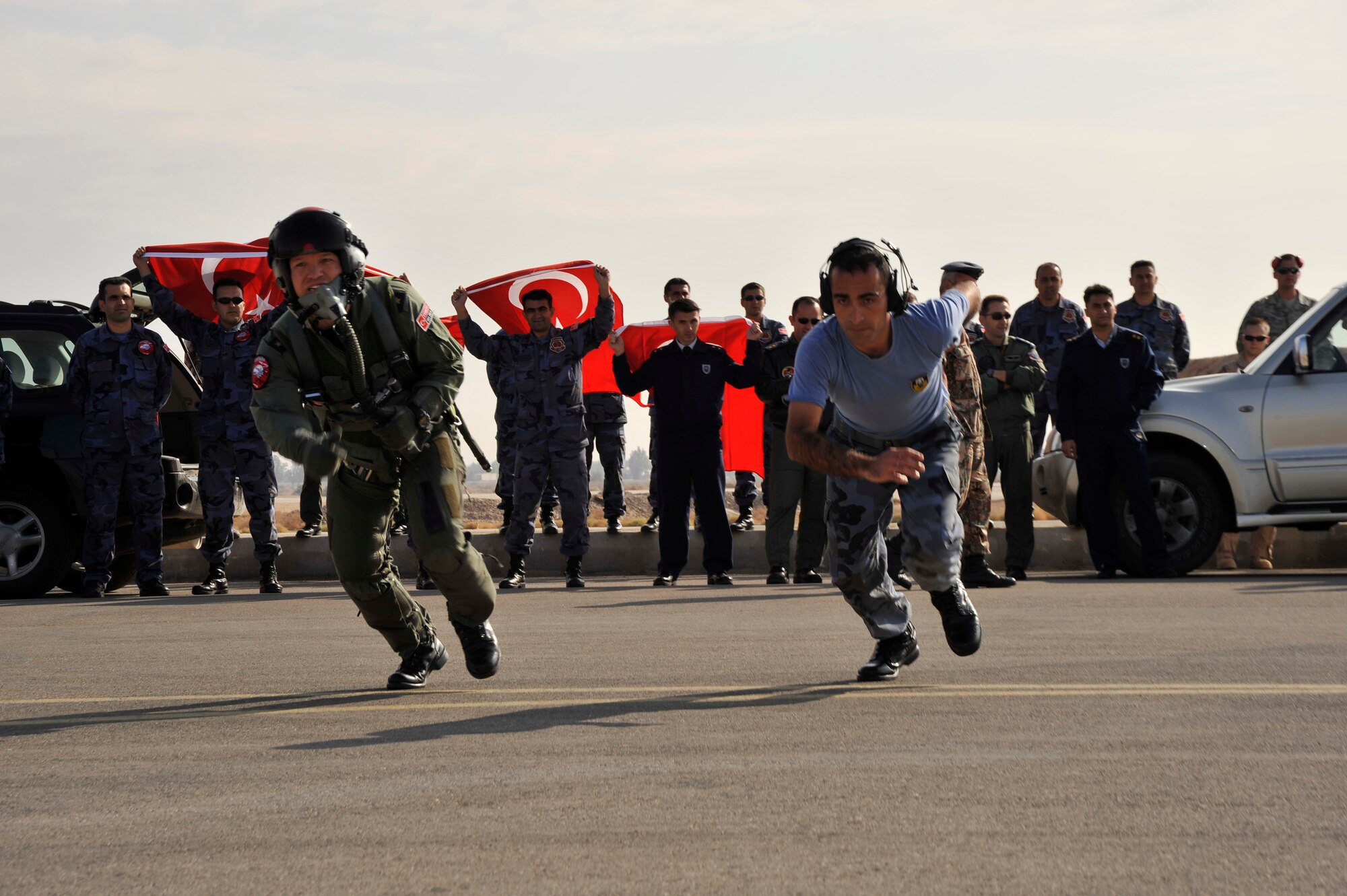 A Turkish pilot and crew chief run to their F-16 during the scramble launch competition at Falcon Air Meet 2008. Each team reacts to a simulated threat and must get their aircraft launched in the in the shortest amount of time without incurring penalties for safety violations. 