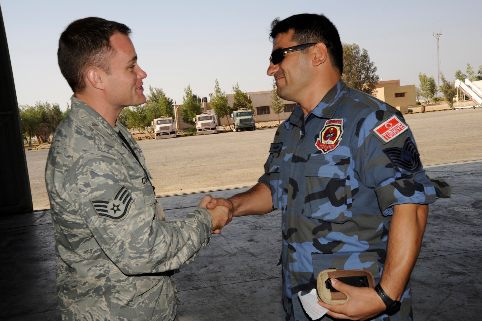 An American F-16 crew chief meets with a Turkish F-16 crew chief meet and greet during a traditional Arabic breakfast prior to the start of the Falcon Air Meet 2008.  The exercise is a friendly competition centered on the F-16 Fighting Falcon, the world?s only multi-role fighter jet. F-16 units from Turkey, Jordan and the 421st Fighter Squadron from Hill Air Force Base in Utah are competing in the areas of maintenance and flying operations. Members of the 140th Wing, Colorado Air National Guard, are judging the event. The annual meet, inspired by Prince Feisal Bin Al Hussein, special assistant to the chairman of the Joint Chiefs of Staff of the Jordanian Armed Forces, aims to improve relations between Jordan and its partner nations and the promote stability in the Middle East region. The country of Jordan and the state of Colorado are linked through the National Guard State Partnership Program, which link states with various countries in order to foster mutual interests and establish long-term relationships across all levels of society. This is the third FAM in history.