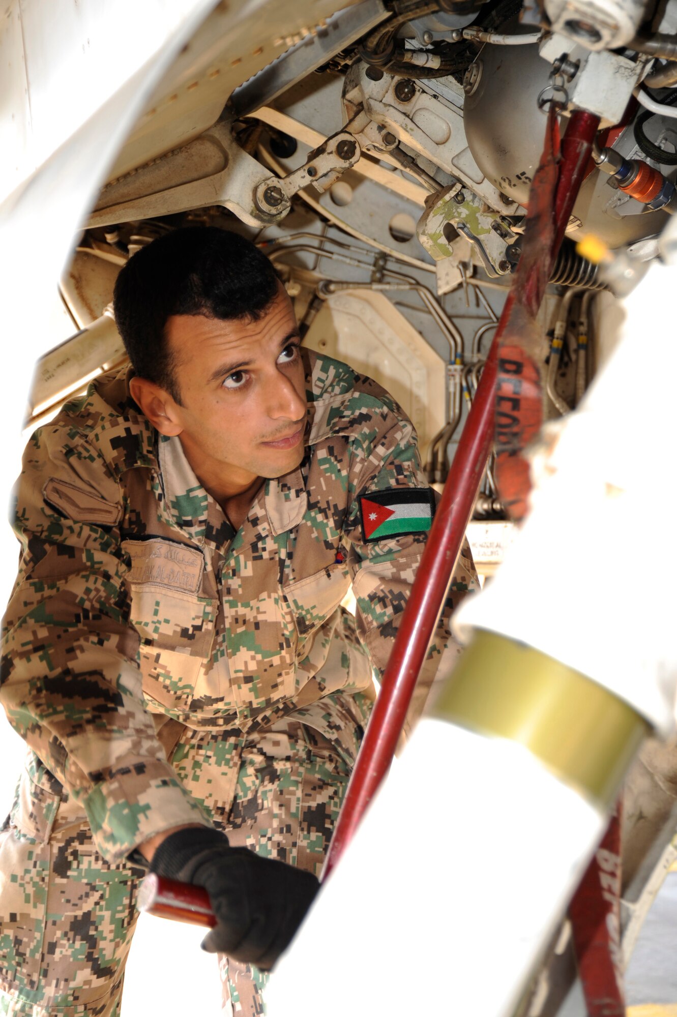 A Royal Jordanian Air Force crewmember works on a Royal Jordanian Air Force F-16 Oct. 21 during the Falcon Air Meet 2008.  The exercise is a friendly competition centered on the F-16 Fighting Falcon, the world?s only multi-role fighter jet. F-16 units from Turkey, Jordan and the 421st Fighter Squadron from Hill Air Force Base in Utah are competing in the areas of maintenance and flying operations. Members of the 140th Wing, Colorado Air National Guard, are judging the event. The annual meet, inspired by Prince Feisal Bin Al Hussein, special assistant to the chairman of the Joint Chiefs of Staff of the Jordanian Armed Forces, aims to improve relations between Jordan and its partner nations and the promote stability in the Middle East region. The country of Jordan and the state of Colorado are linked through the National Guard State Partnership Program, which link states with various countries in order to foster mutual interests and establish long-term relationships across all levels of society. This is the third FAM in history. 