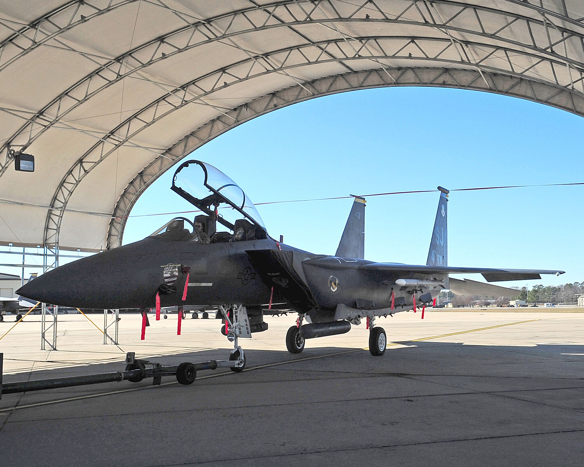 An F-15E Strike Eagle prepares to cut a ribbon on the grand opening of the new flightline shelters Dec. 30, 2008 on Seymour Johnson Air Force Base, N.C. These shelters, which are able to withstand up to 110-mph winds, will help protect both the Strike Eagles and their maintainers during inclement weather.