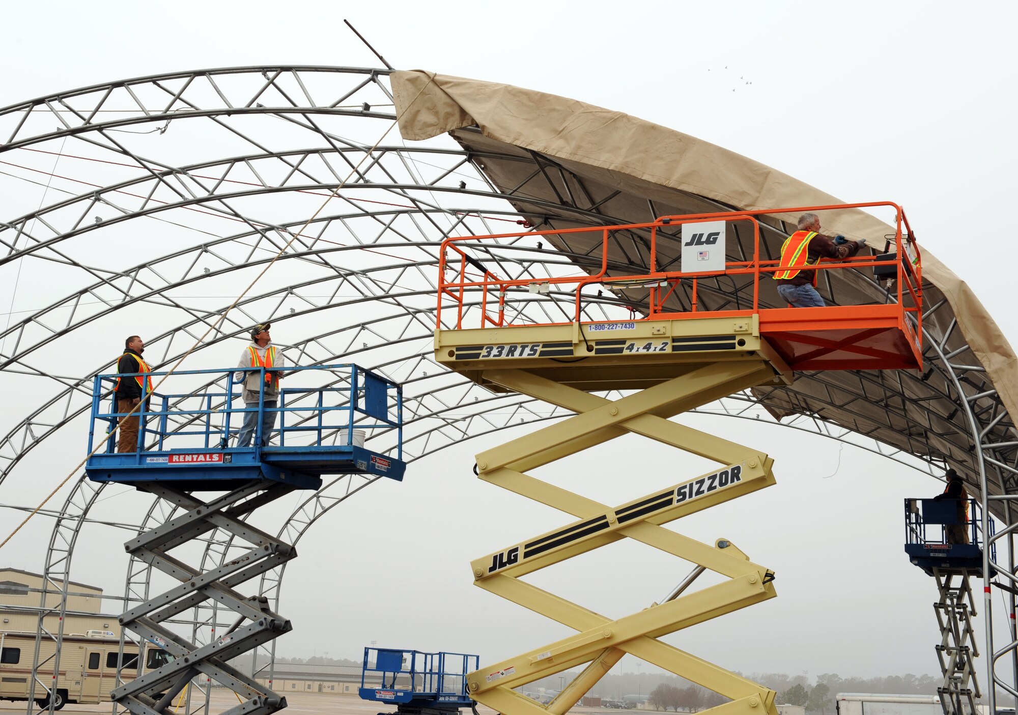 Crew members assemble new shelters for the F-15E Strike Eagle aircraft here at Seymour Johnson Air Force Base Dec. 18, 2008. These shelters, which are able to withstand up to 110-mph winds, will help protect both the F-15E and their maintainers during inclement weather.