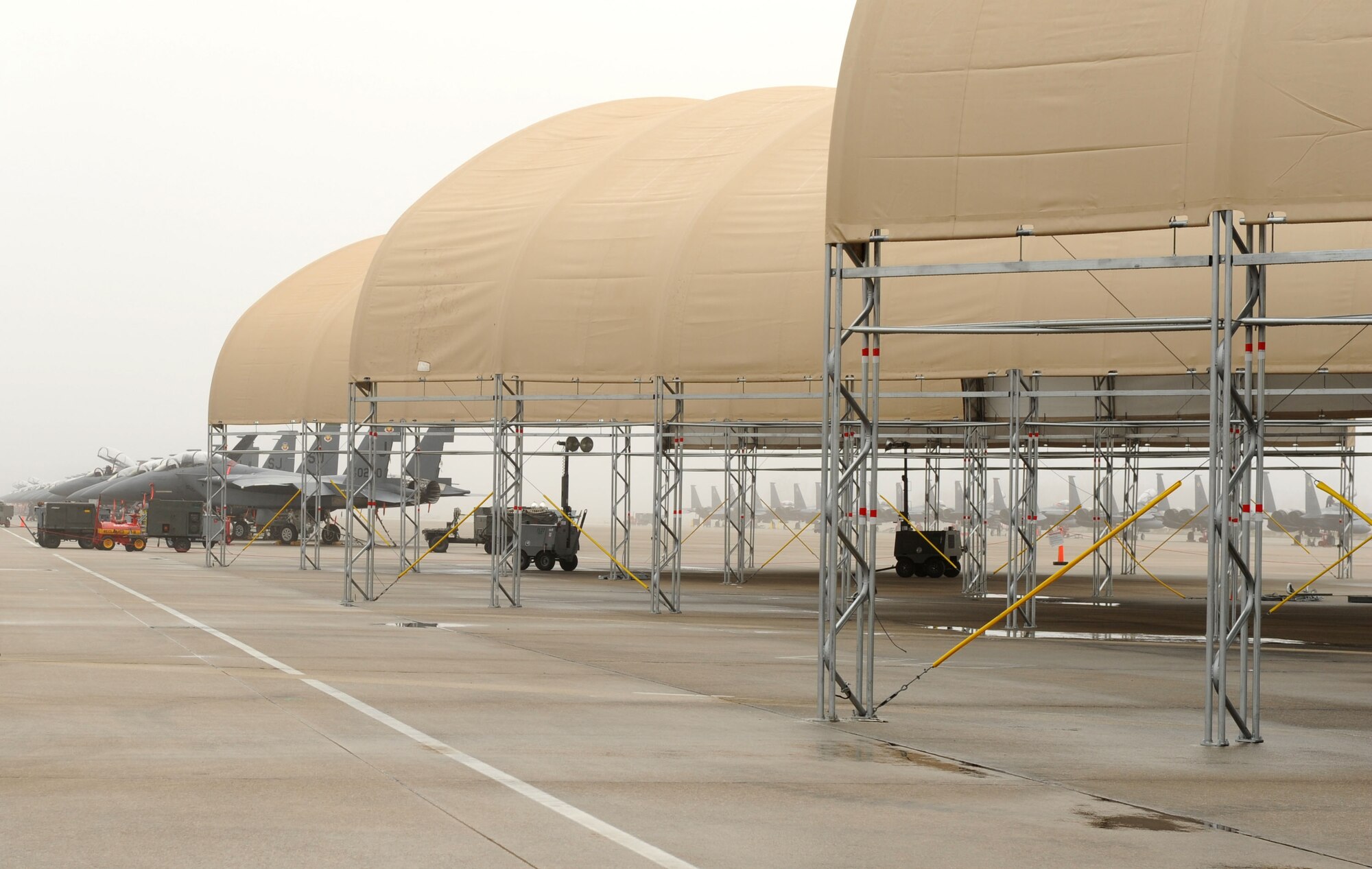 New shelters for the F-15E Strike Eagle aircraft at Seymour Johnson Air Force Base, N.C., stand constructed on the flightline Dec. 18, 2008. These shelters, which are able to withstand up to 110-mph winds, will help protect both the Strike Eagles and their maintainers during inclement weather.