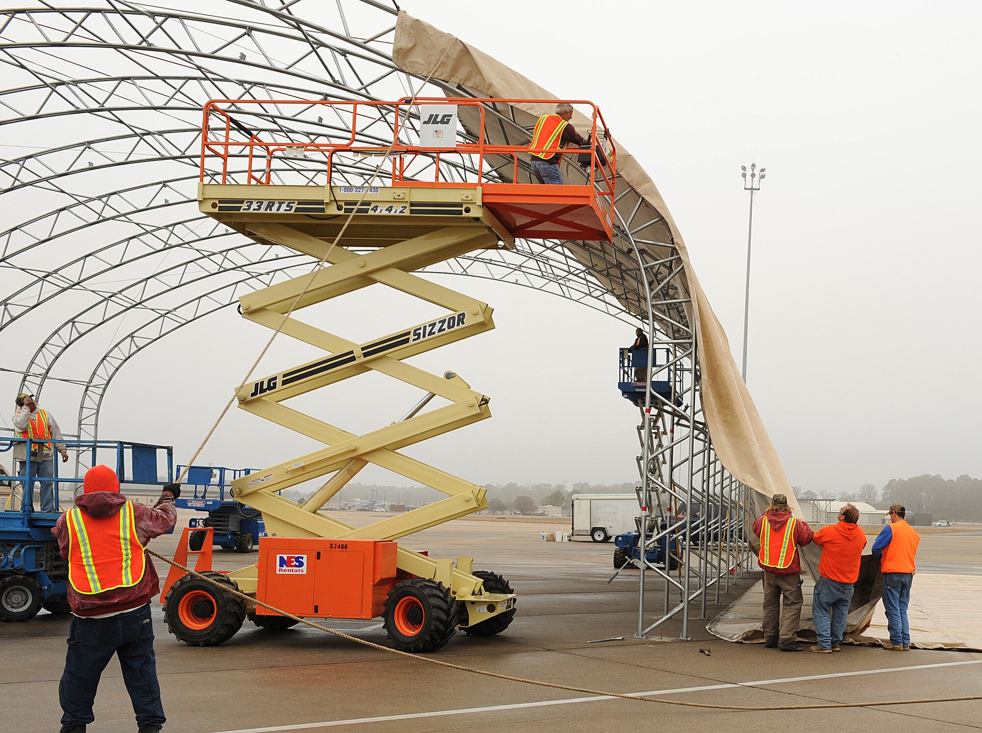 Crew members assemble new shelters for F-15E Strike Eagle aircraft here at Seymour Johnson Air Force Base, N.C., Dec. 18, 2008. These shelters, which are able to withstand up to 110-mph winds, will help protect both the Strike Eagles and their maintainers during inclement weather.