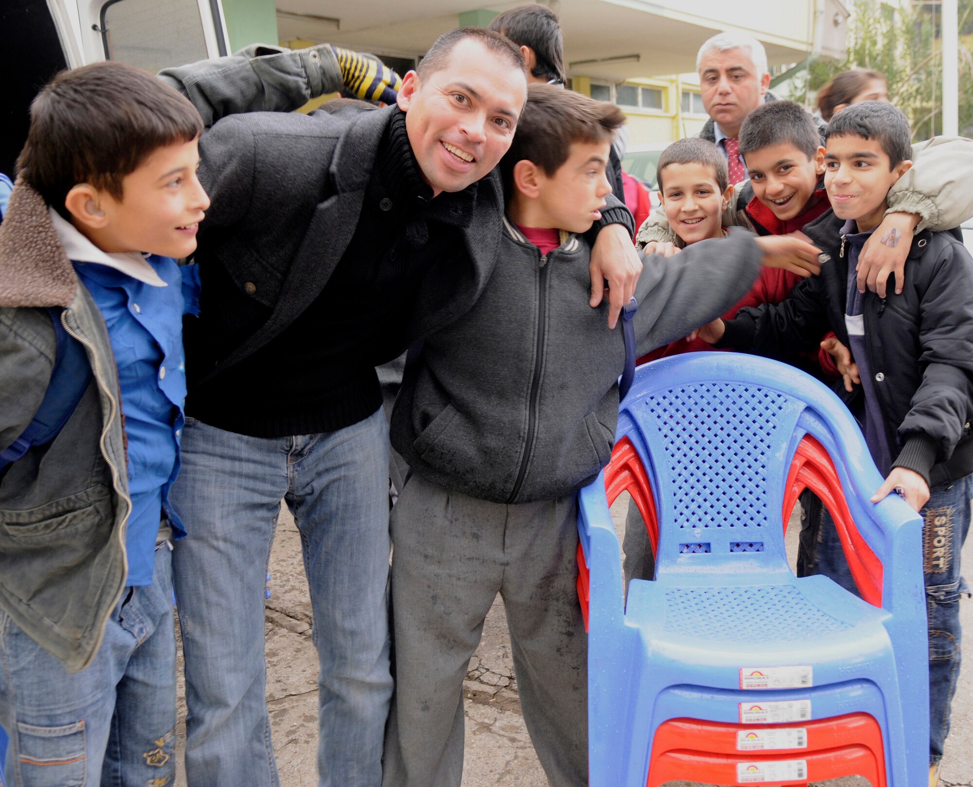 Staff Sgt. Kirt Dicen, 39th Air Base Wing chaplain assistant, poses with children from the local Seyhan School for the Deaf Jan.6. Members of Incirlik donated approximately 300 pounds of toys and 50 plastic chairs to improve quality of life for local children which were delivered by the 39th Operations Squadron and 39th Air Base Wing chapel. (U.S. Air Force photo by Airman 1st Class Amber Russell)