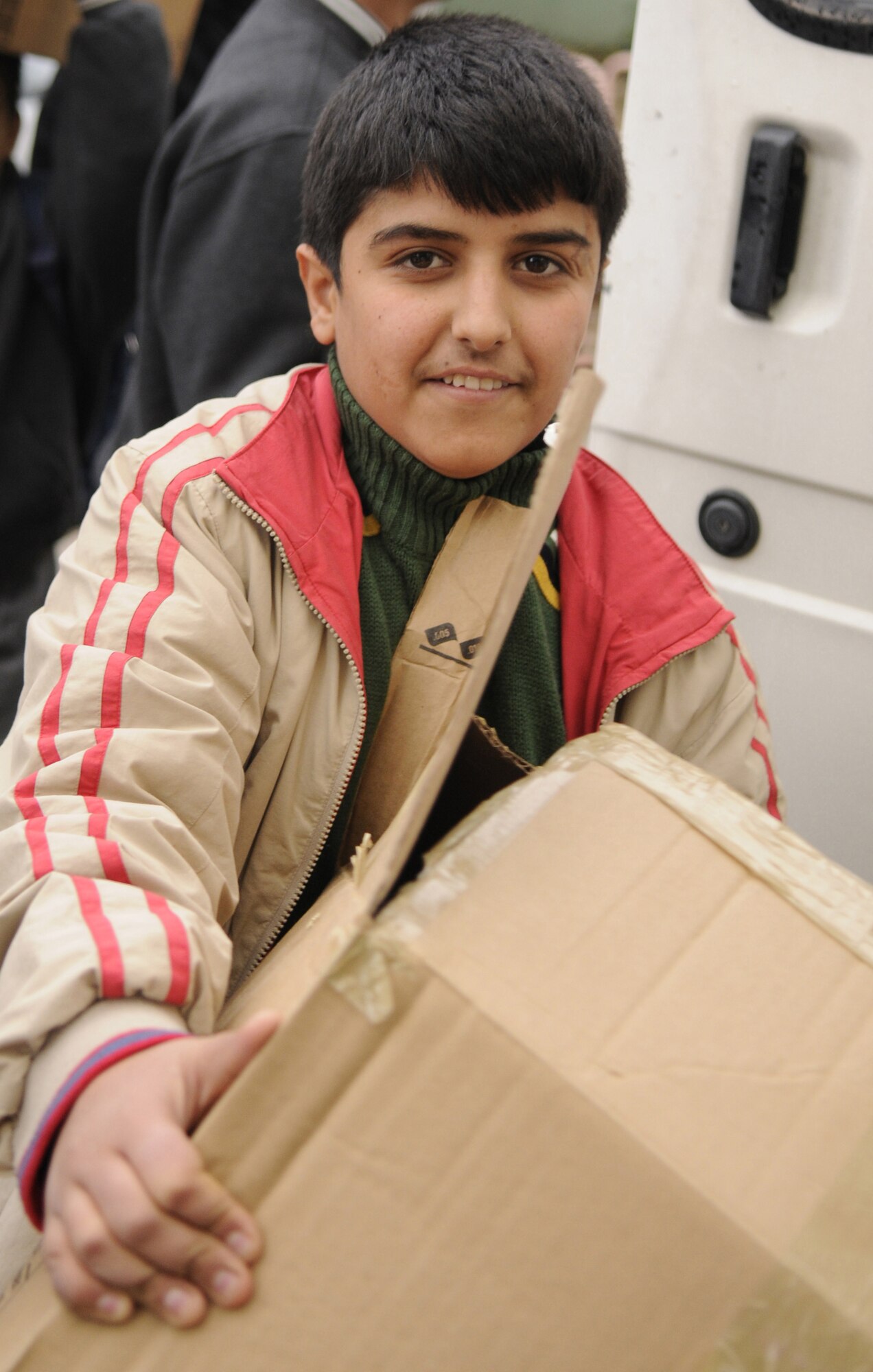 A boy from the local Seyhan School for the Deaf tears into a box Jan.6. Members of Incirlik donated approximately 300 pounds of toys and 50 plastic chairs to improve quality of life for local children which were delivered by the 39th Operations Squadron and 39th Air Base Wing chapel. (U.S. Air Force photo by Airman 1st Class Amber Russell)