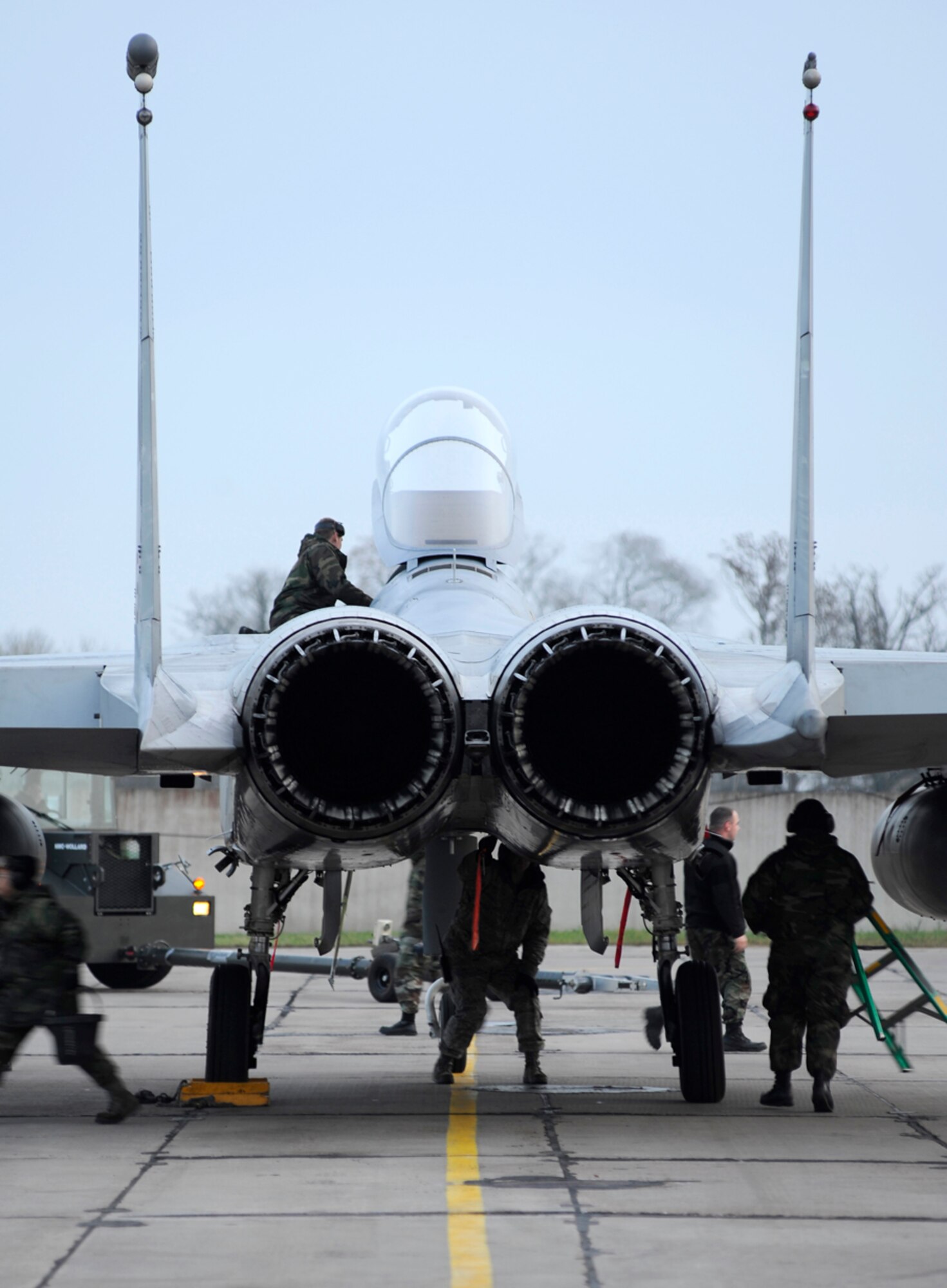Crew chiefs from the 493rd Expeditionary Fighter Squadron work diligently to inspect an F-15 Eagle after landing in Siauliai, Lithuania. The F-15's in Siauliai were required to be on alert status 24 hours a day to support the ongoing NATO Baltic Air Policing mission there. (U,S. Air Force photo by Staff Sgt. Brian Ferguson)