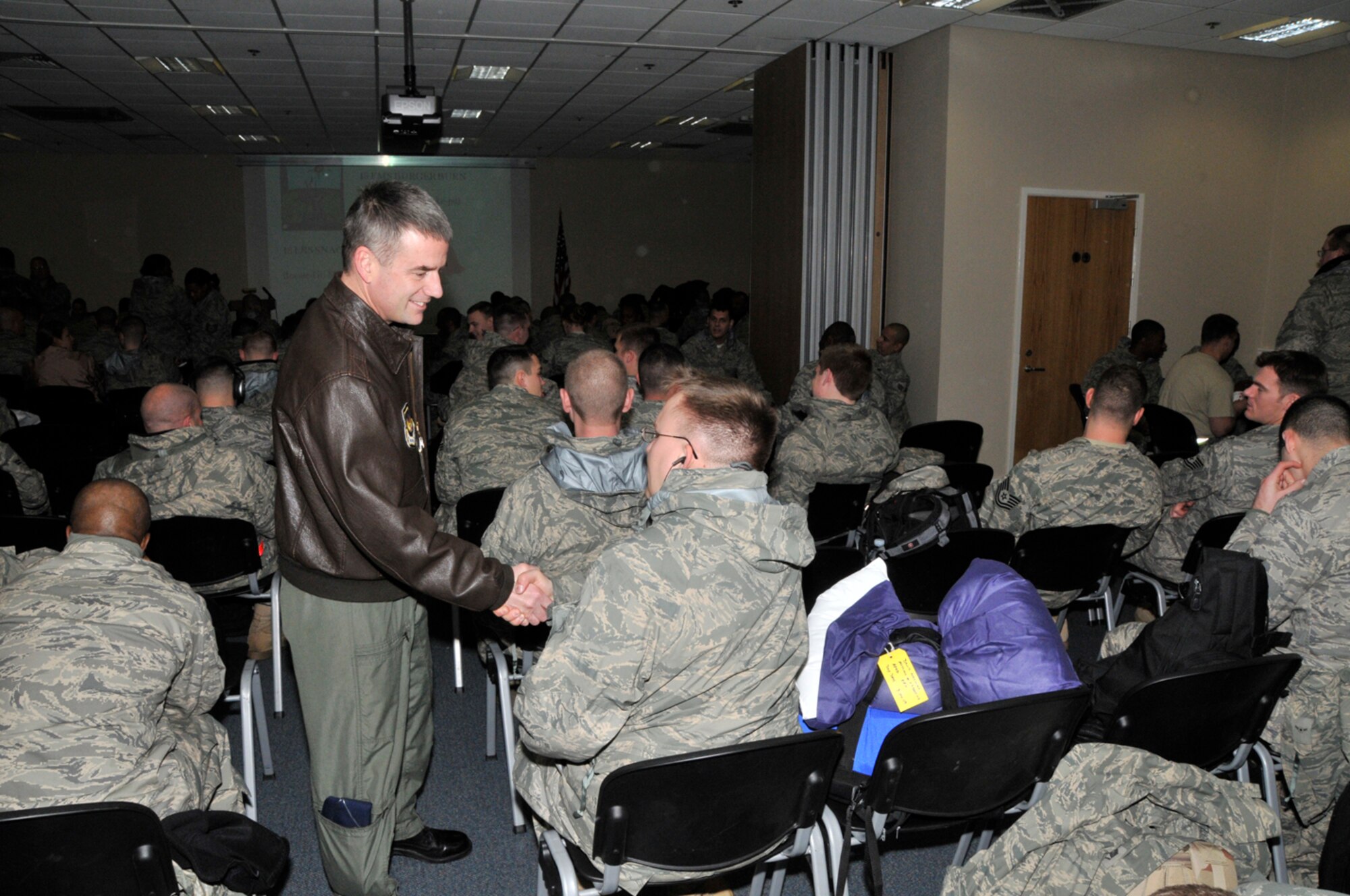 Col. Jay Silveria, 48th Fighter Wing commander, greets Airmen at unit deployment facility, Jan. 3 at RAF Lakenheath, England. The commander wished all the Airmen a safe a speedy return from their deployment to Southwest Asia in support of Operation Enduring Freedom. (U.S. Air Force photo by Airman 1st Class Perry Aston)