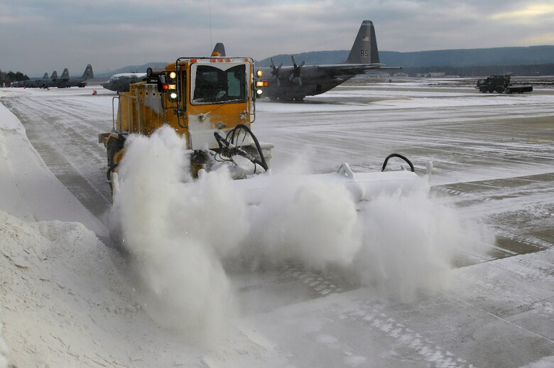 Members of Ramstein Air Field Management use a snow removal truck to clear snow off ramp one Jan. 6, 2008, before the day's mission. (U.S. Air Force photo by Airman 1st Class Kenny Holston)