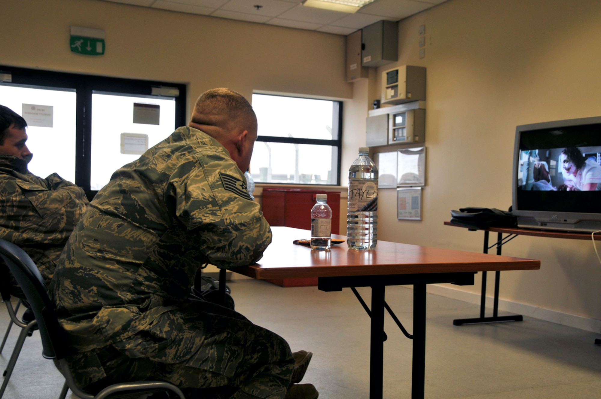 Airmen watch movies while they wait for the flight to Southwest Asia, Jan. 3 at RAF Lakenheath, England. More than 300 Airmen from the 48th Fighter Wing deployed in support of Operation Enduring Freedom. (U.S. Air Force photo by Airman 1st Class Perry Aston)