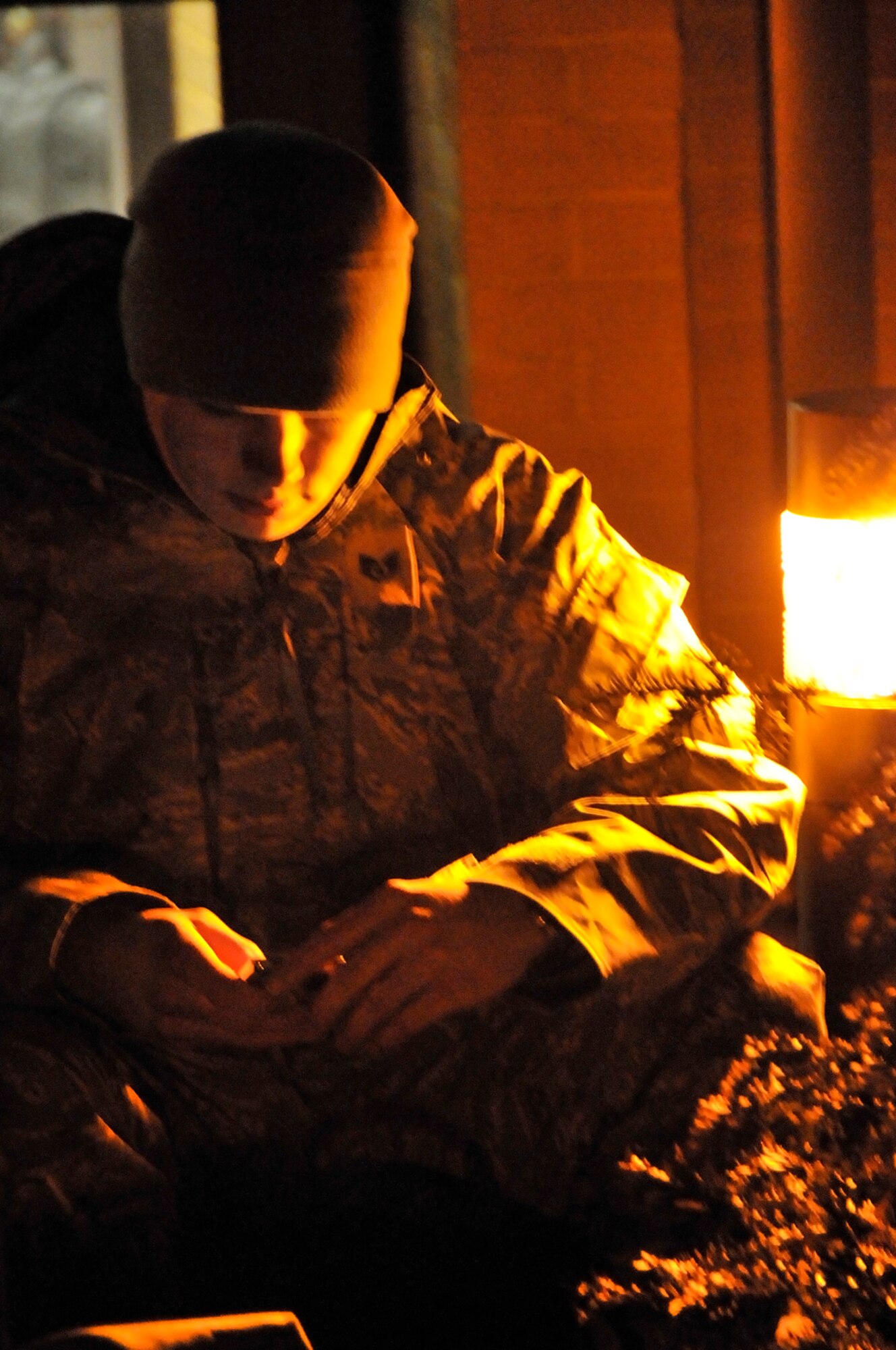Staff Sgt. Shawn Mackey, 48th Munitions Squadron, creates a playlist for the flight to Southwest Asia while he waits for the buses to take him to the unit deployment facility, Jan. 3 at RAF Lakenheath, England. More than 300 Airmen from the 48th Fighter Wing deployed in support of Operation Enduring Freedom. (U.S. Air Force photo by Airman 1st Class Perry Aston)