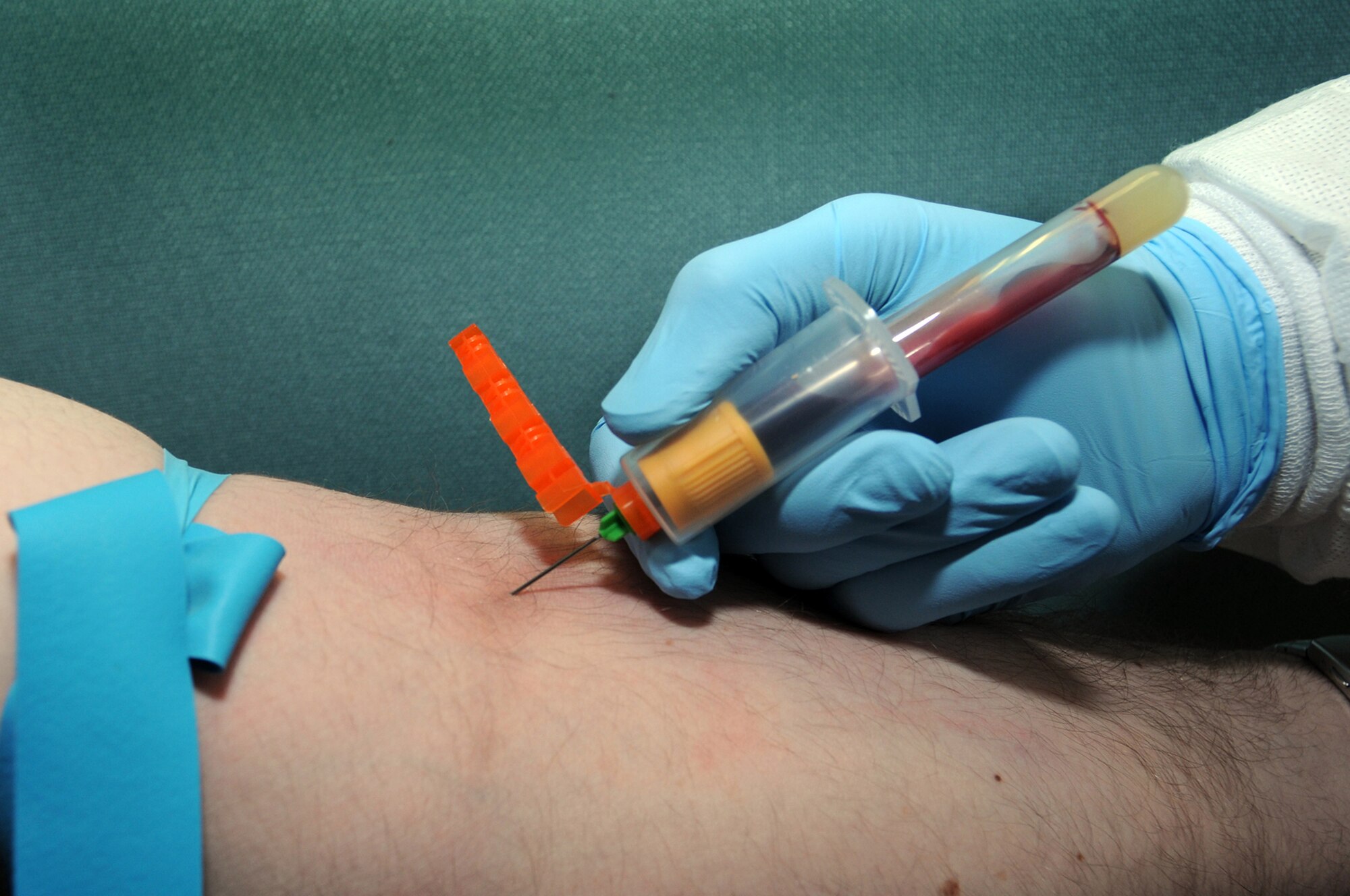 Senior Airman Willie Ellis, 435th Medical Support Squadron lab technician, draws blood at Ramstein Air Base Jan. 6, 2009. After the blood is drawn, it will be placed in the chemical analyzer to test electrolytes, cholesterol and liver function. (U.S. Air Force photo by Senior Airman Kelly LeGuillon)