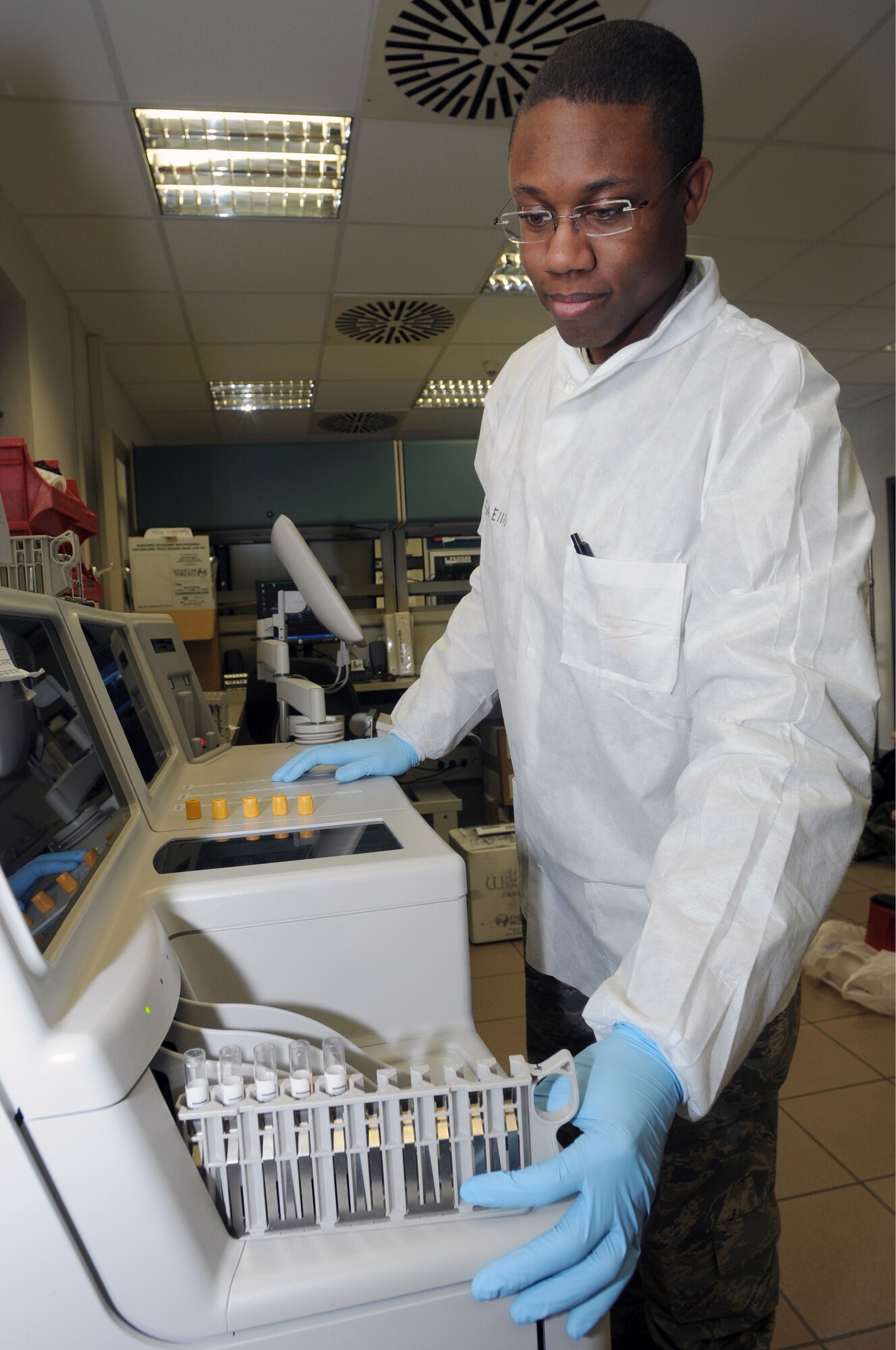 Senior Airman Willie Ellis, 435th Medical Support Squadron lab technician, places blood samples into the chemical analyzer at Ramstein Air Base Jan. 6, 2009. The chemical analyzer tests electrolytes, cholesterol and liver function. (U.S. Air Force photo by Senior Airman Kelly LeGuillon)