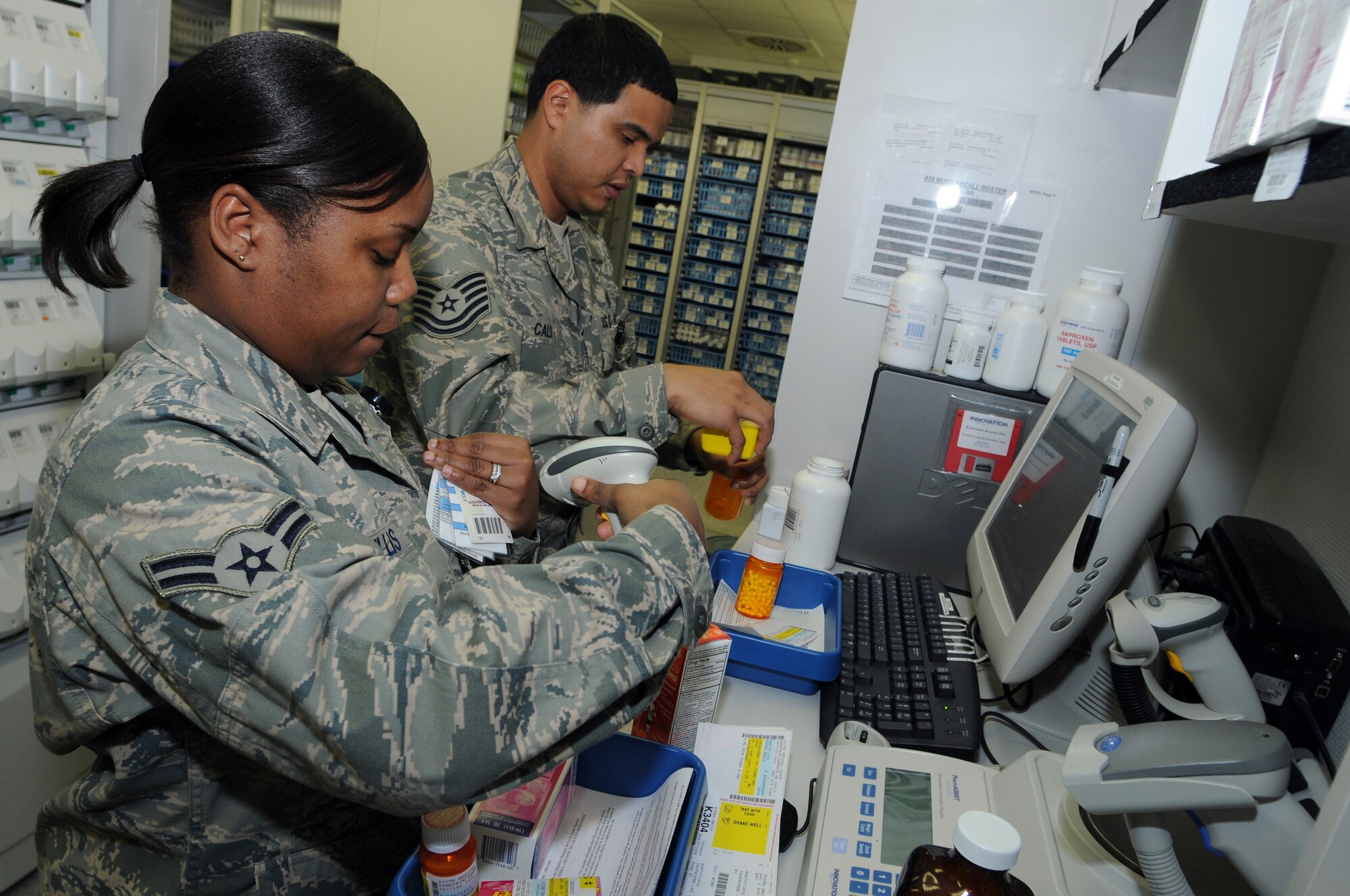Airman 1st Class Crystal Willis (front) and Tech Sgt. Chris Calo, 435th Medical Operations Squadron pharmacy technicians, fill prescriptions at Ramstein Air Base Jan. 6, 2009. The Ramstein pharmacy fills an average of 115,000 prescriptions a year and is the second busiest pharmacy in U.S. Air Forces in Europe. (U.S. Air Force photo by Senior Airman Kelly LeGuillon)