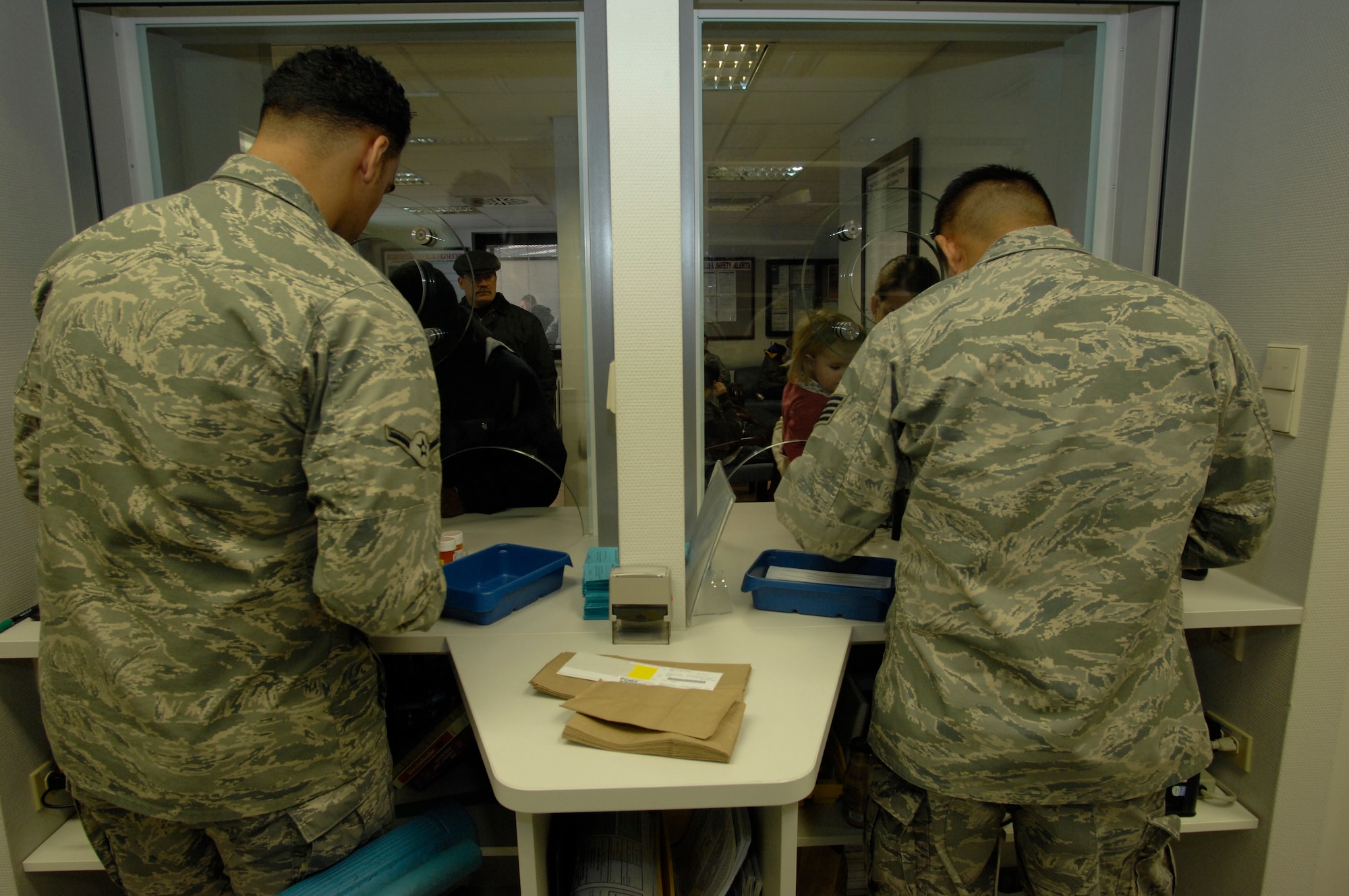 (Left) Airman Angelo Vazquez and Staff Sgt. Tsering Chophel, 435th Medical Operations Squadron pharmacy technicians, disperse medications to customers at Ramstein Air Base Jan. 6, 2009. The Ramstein pharmacy fills 115,000 prescriptions a year and is the second busiest pharmacy within the U.S. Air Forces in Europe. (U.S. Air Force photo by Senior Airman Amber Bressler)
