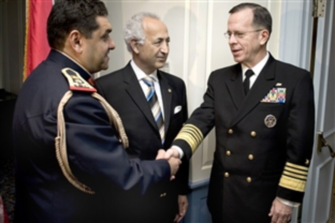 U.S. Navy Adm. Mike Mullen, chairman of the Joint Chiefs of Staff, (right) is greeted by Iraqi Defense Attache Staff Brig. Gen. Ismael H. Alsodani (left) and Iraqi Ambassador to the U.S. Samir Al Sumaidaie at the celebration marking the 88th anniversary of the creation of the Iraqi armed forces, Washington, D.C., Jan. 6, 2009. Mullen spoke to the gathering thanking the Iraqi people for their sacrifice and reiterated the bond that the two countries have in defending democratic principals.