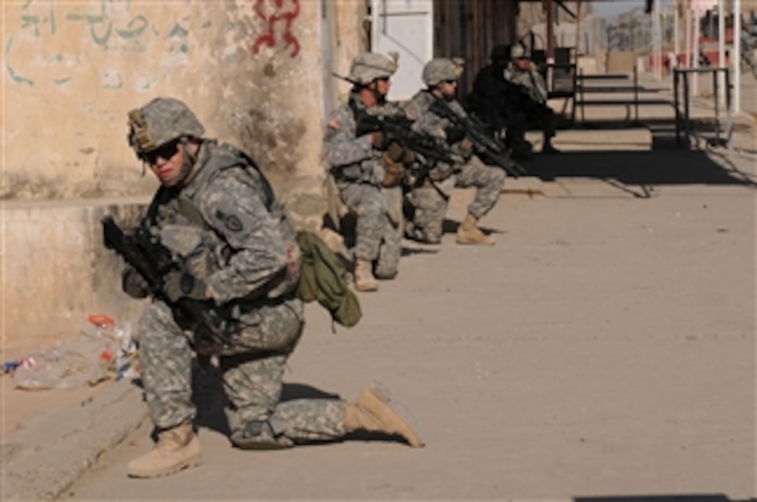 U.S. Army soldiers from Alpha Company, 2nd Infantry Battalion, 3rd Brigade Combat Team, 25th Infantry Division provide security during a patrol in Siniyah, Iraq, on Dec. 16, 2008.  