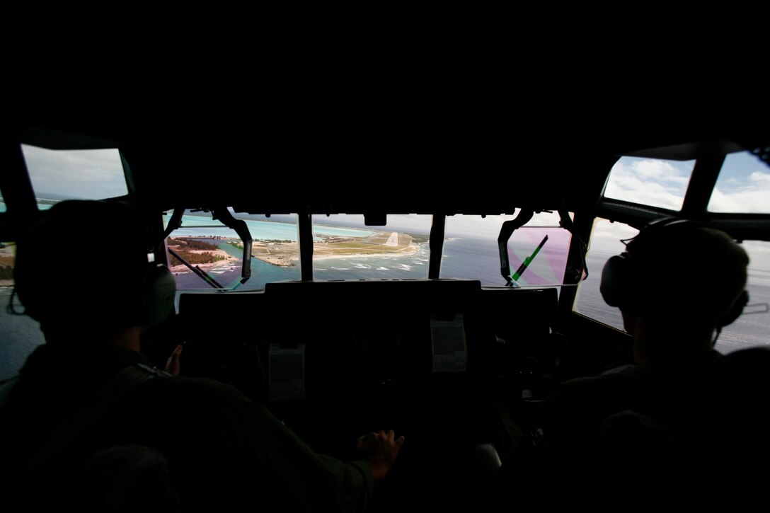 On their final approach to Wake Island on Jan. 8, 2009, pilots Capt. Chris Maloney, left, and Capt. Chris Kocab prepare to land a KC-130 Hercules cargo plane carrying an advance maintenance crew from Marine Attack Squadron 211. The advance maintenance crew prepared for Harrier landings at stops en route to Iwakuni, Japan, where the squadron recently deployed to for a tour with the 31st Marine Expeditionary Unit. The squadron's return to Wake Island marks the first time since May 1993 the bulk of the squadron, nicknamed the "Wake Island Avengers," has returned to its symbolic birthplace. From Dec. 8-23, 1941, a handful of the unit's Marines helped to defend the island from an overwhelming Japanese invasion force even after most of their planes were destroyed. VMA-211 is based in Yuma, Ariz. The pilots were members of Marine Aerial Refueler Transport Squadron 352, based in Miramar, Calif. (Photo by Gunnery Sgt. Bill Lisbon)