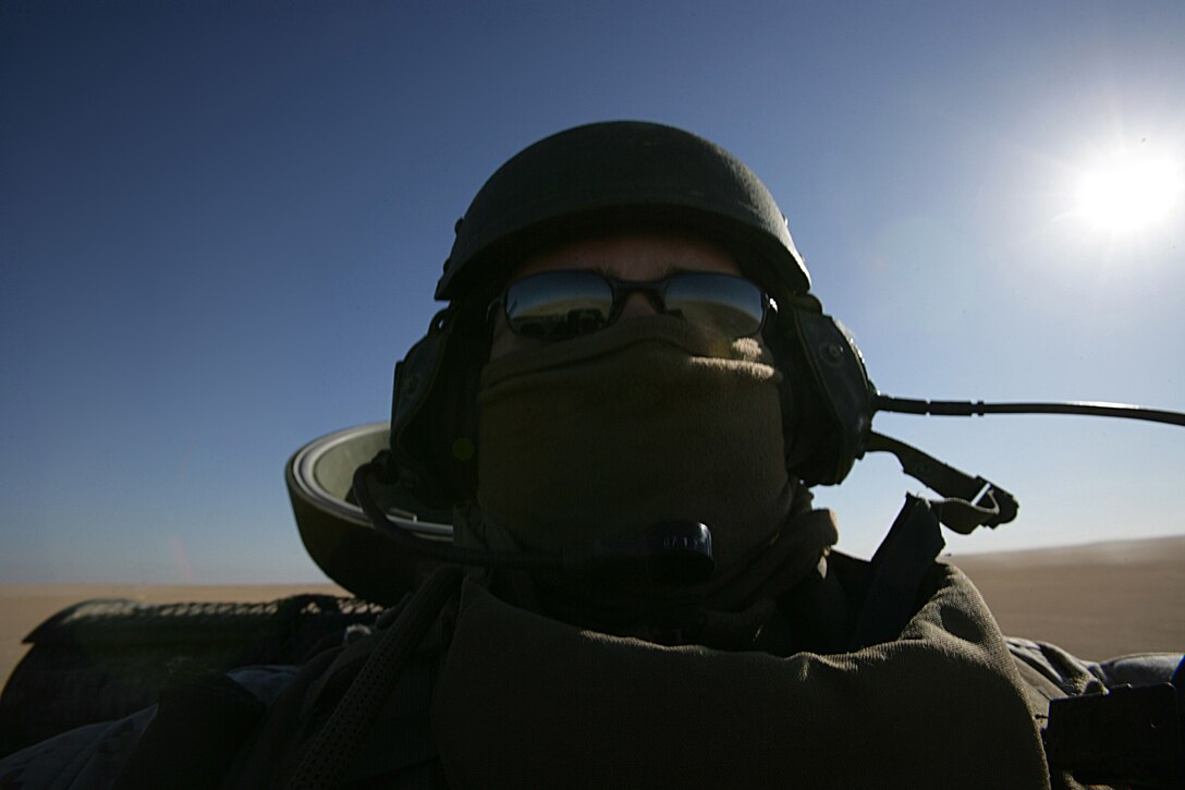 A Marine rides in an Amphibious Assault Vehicle from the AAV Platoon, Battalion Landing Team 2/6, 26th Marine Expeditionary Unit, on Udairi Firing Range, Kuwait, Jan. 8, 2009. The Marines went to the range to test fire their MK19 40mm machine guns and their .50 caliber machine guns before training with Kuwaitis later in the week. The 26th MEU is currently conducting sustainment training at Camp Buehring, Kuwait as part of its 2008-2009 deployment.