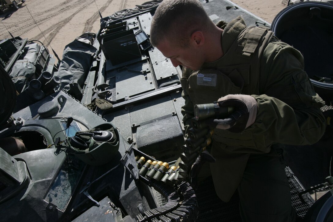 Corporal Justin Sommers, Amphibious Assault Vehicle crew chief, Battalion Landing Team 2/6, 26th Marine Expeditionary Unit, loads his MK19 40mm machine gun with HEDP rounds, on Udairi Firing Range, Kuwait, Jan. 8, 2009.  The MEU's AAV platoon wanted to test fire their main guns before training with Kuwaitis later in the week, said 1st Lt. Michael Cassin, AAV platoon commander. The 26th MEU is currently conducting sustainment training at Camp Buehring, Kuwait as part of its 2008-2009 deployment.